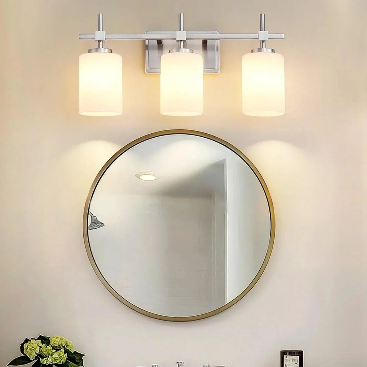 Gold 3-light bathroom vanity light with frosted glass shades and wide metal backplate