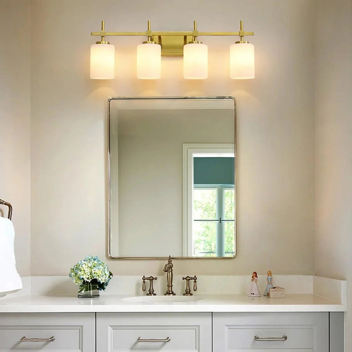 Golden four-light bathroom vanity light with four frosted glass shades