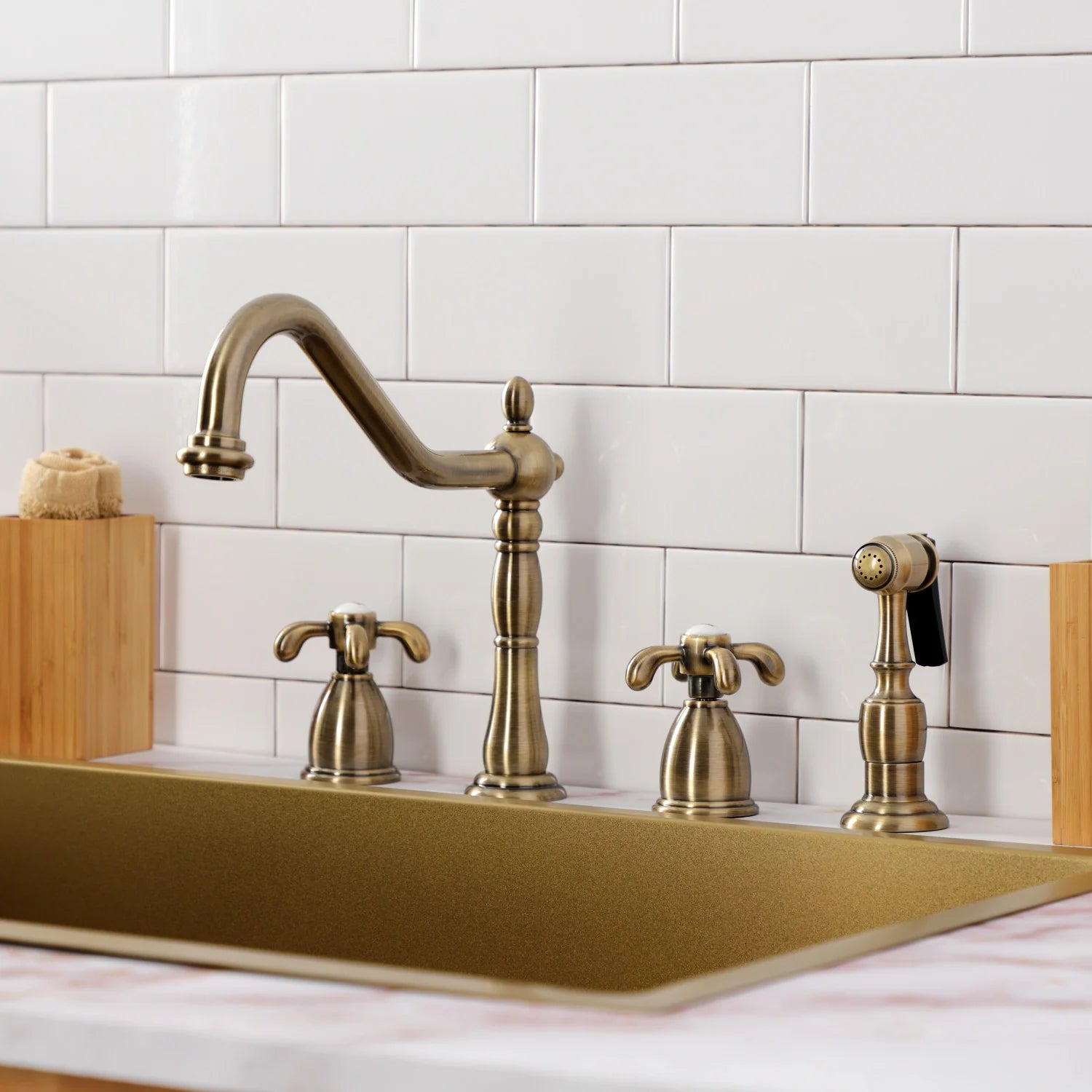 Antique brass kitchen faucet set with gooseneck spout, sprayer, and lever handles