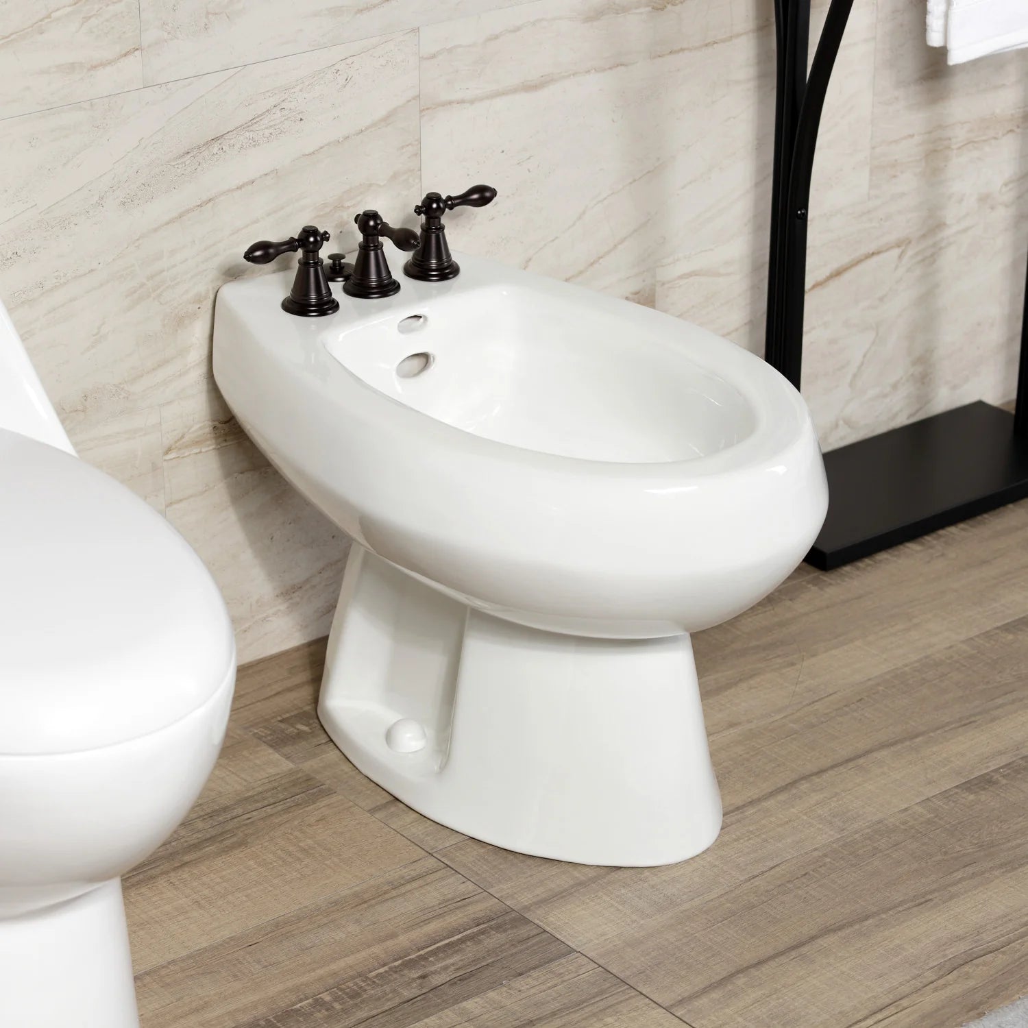 Oil-rubbed bronze three-handle bidet faucet with white bidet bowl and deck controls