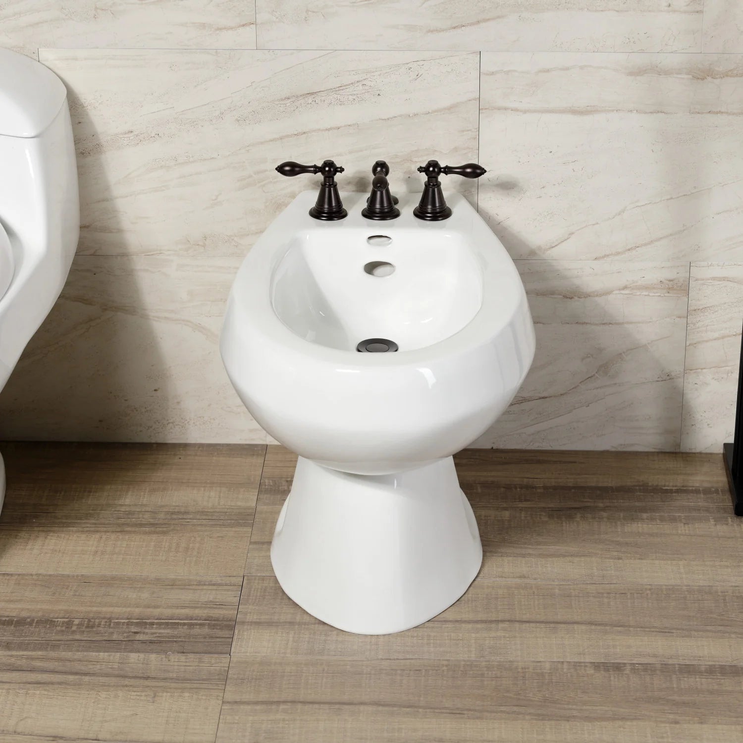Three-handle oil-rubbed bronze bidet faucet on white pedestal bidet