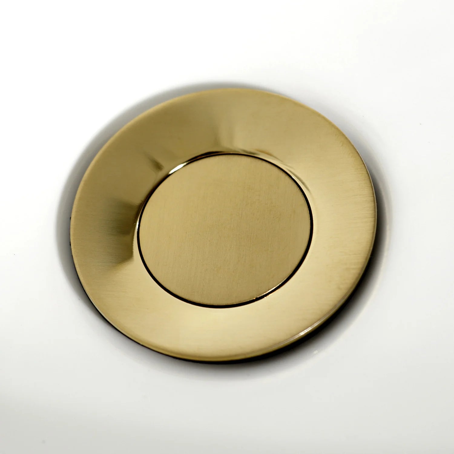 Brushed brass circular escutcheon with center opening for bidet faucet stem