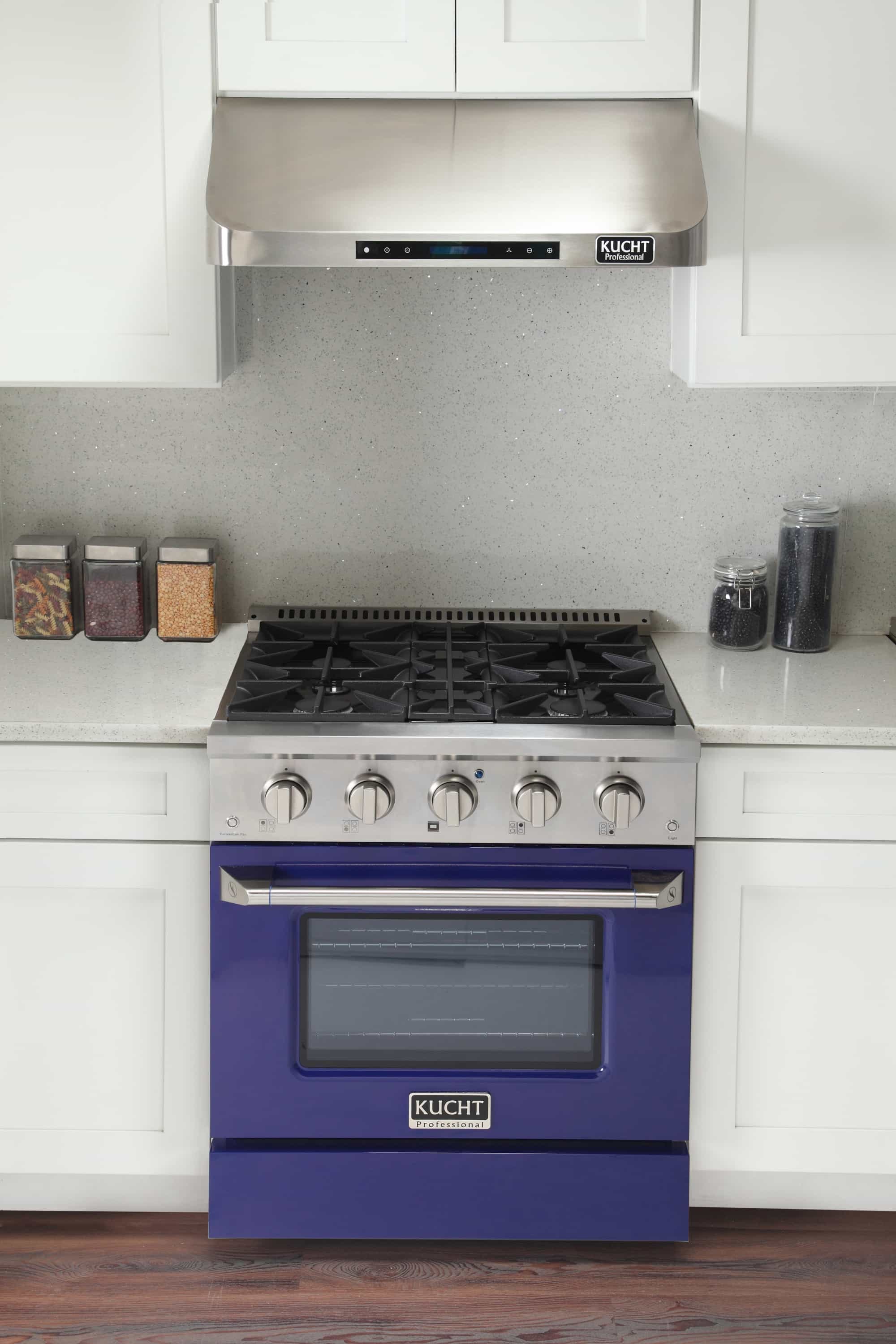 Stainless dual fuel range with blue oven door and 5-burner cooktop in a kitchen setup.