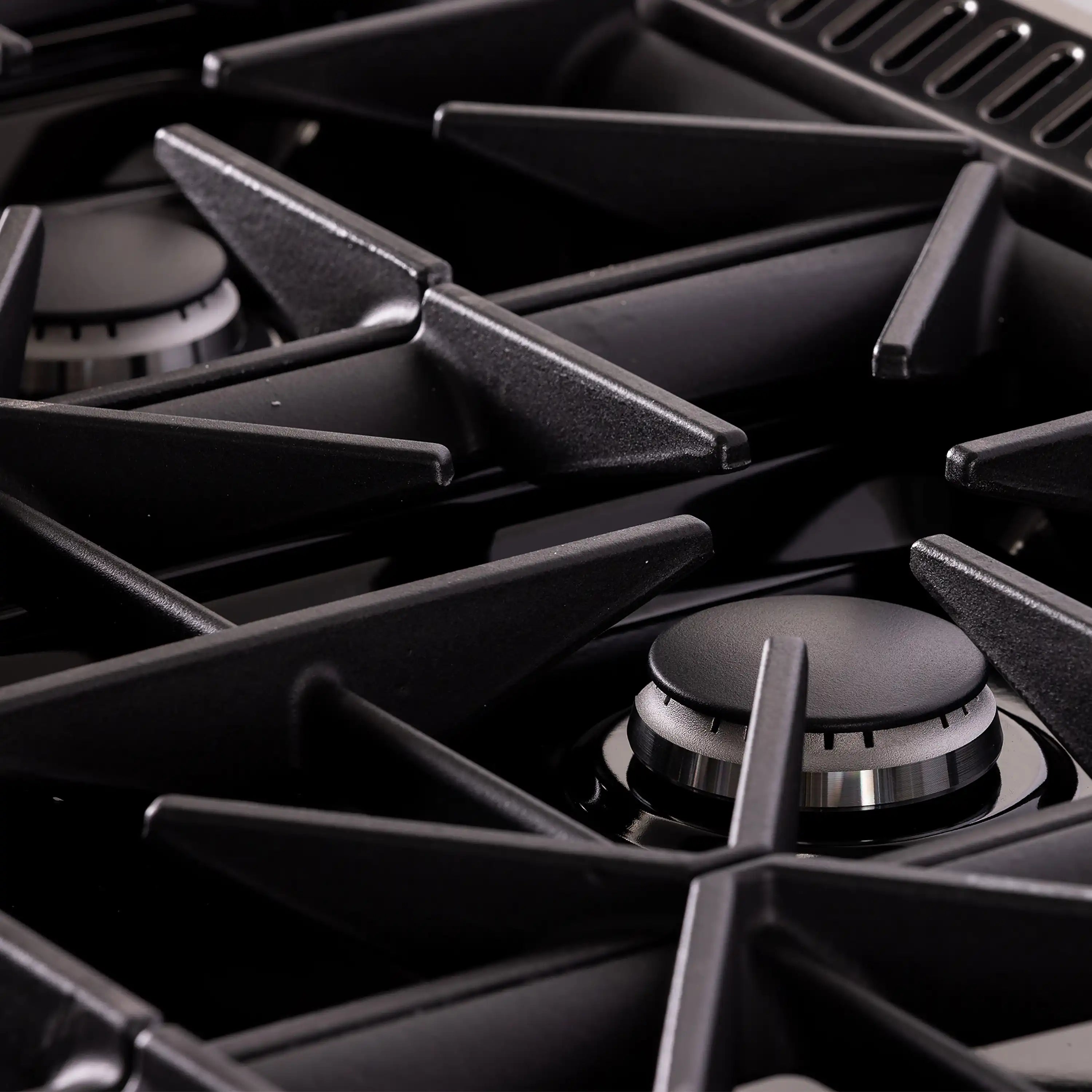 Gas burner with black cast-iron grate and burner support bars