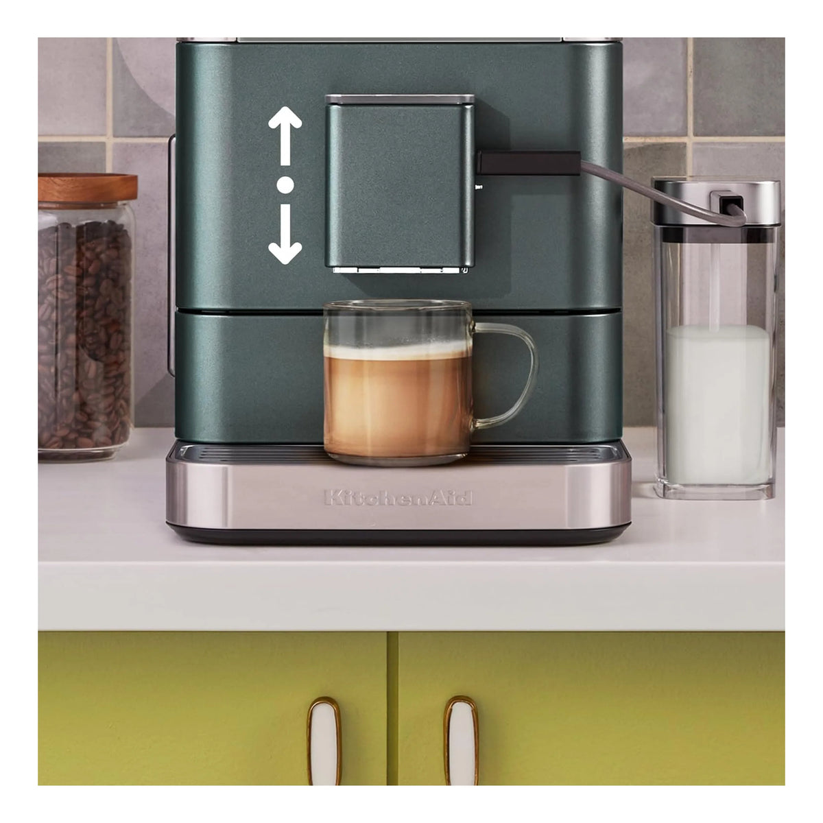 Juniper green espresso machine with milk frother spout, cup, and glass jug on base