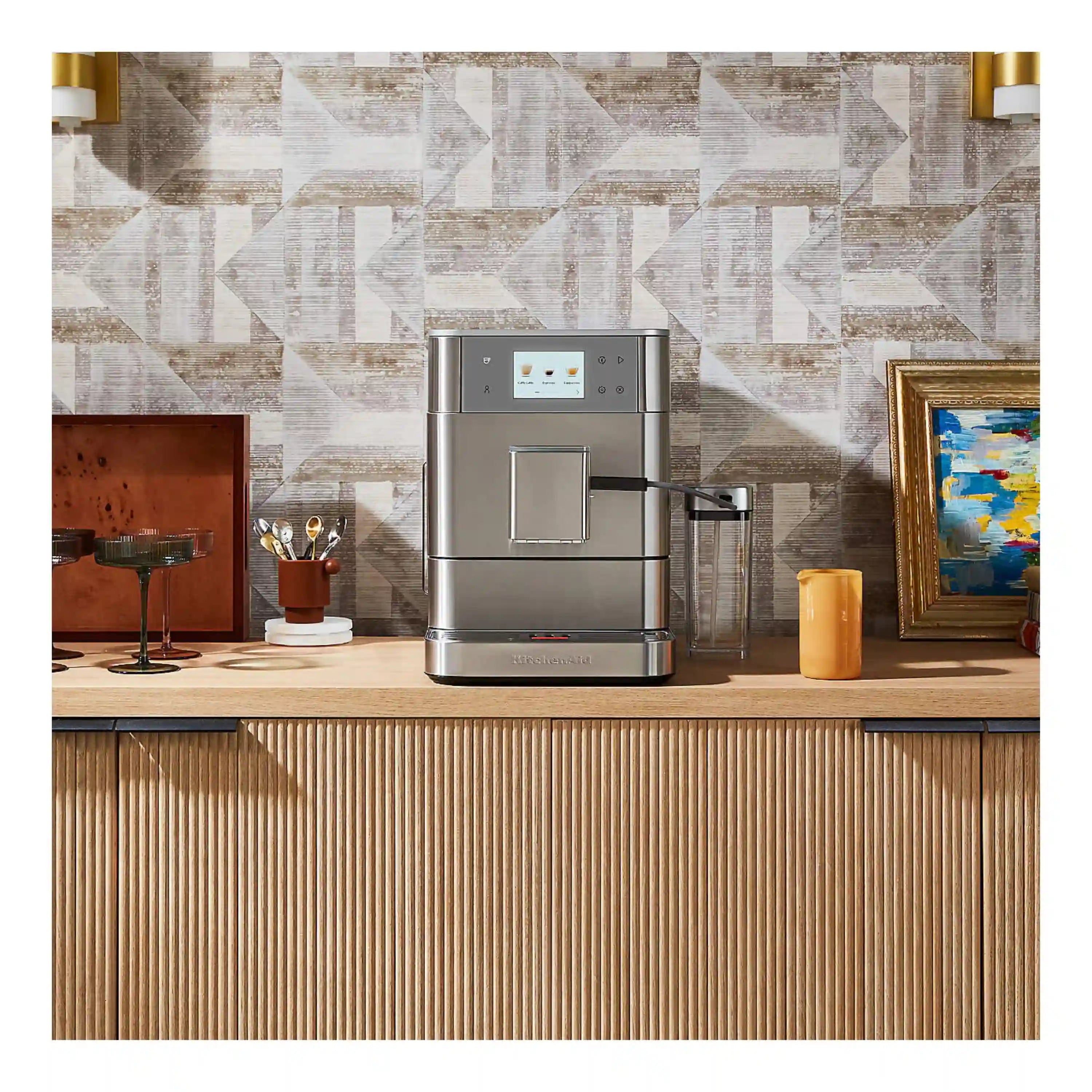 Stainless steel fully automatic espresso machine with built-in milk container on kitchen counter