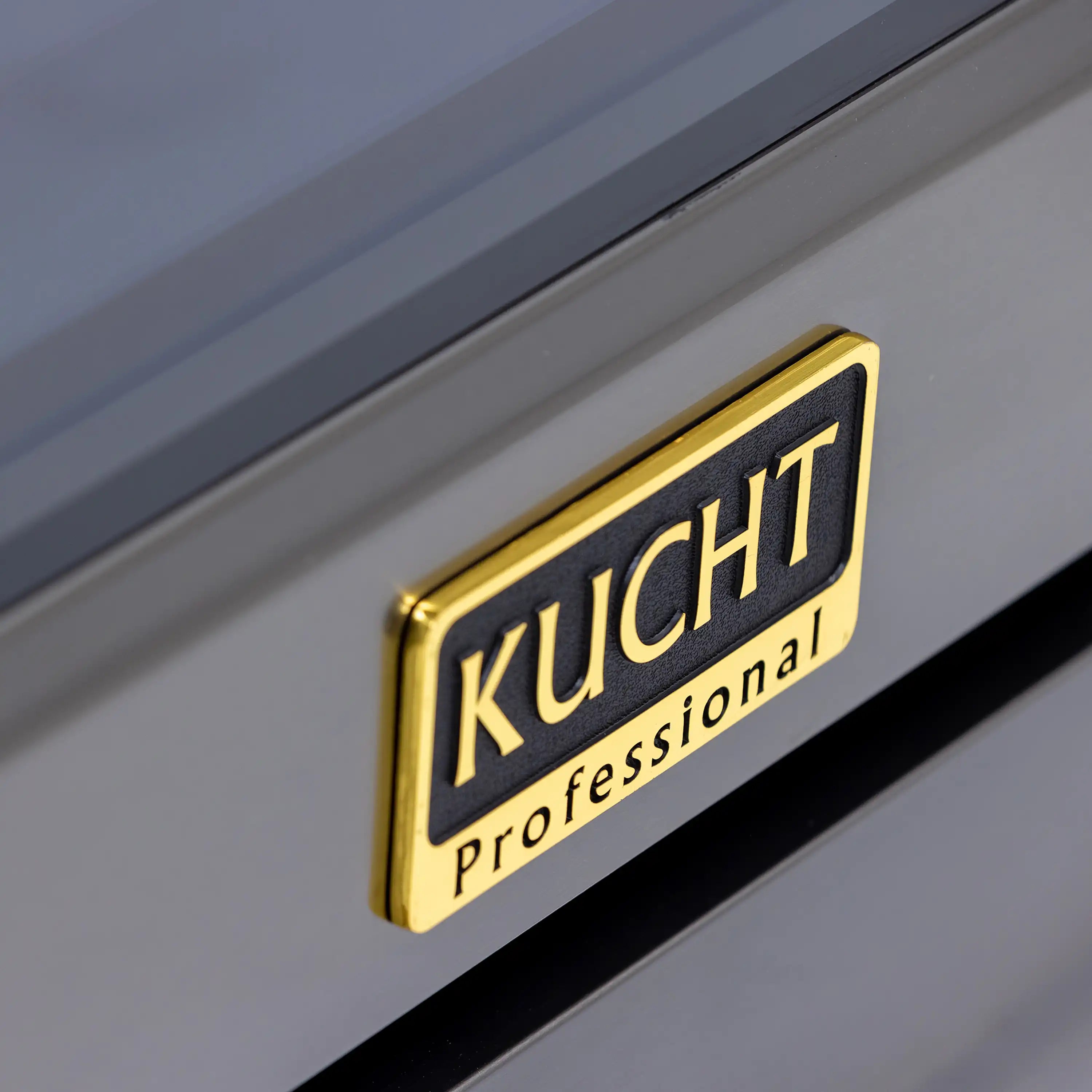 Kucht Professional logo plate on range control panel, dark titanium stainless steel