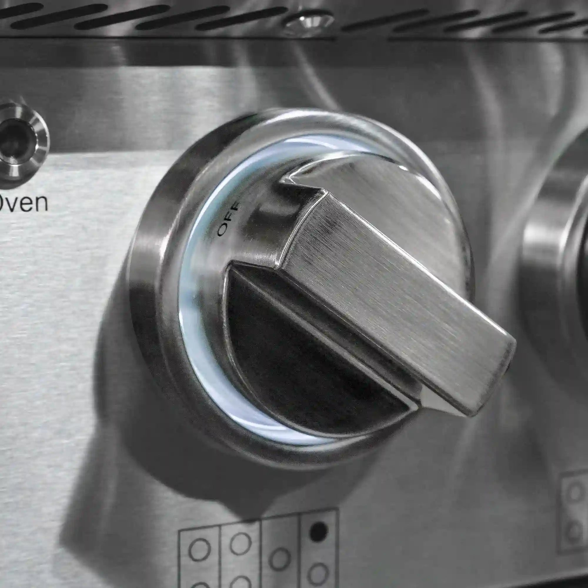 Stainless steel oven temperature control knob on gas range front