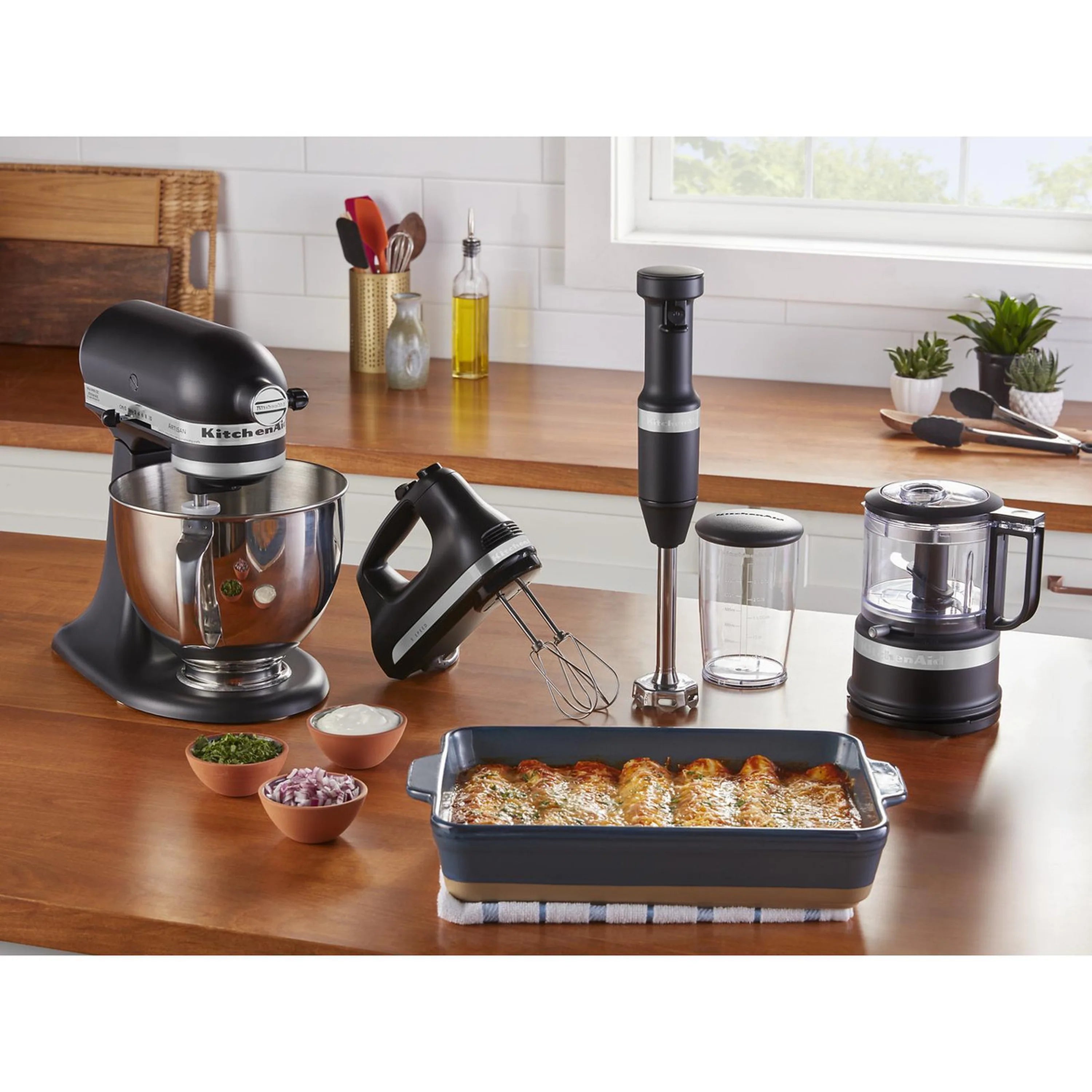 Black matte hand mixer next to countertop appliances