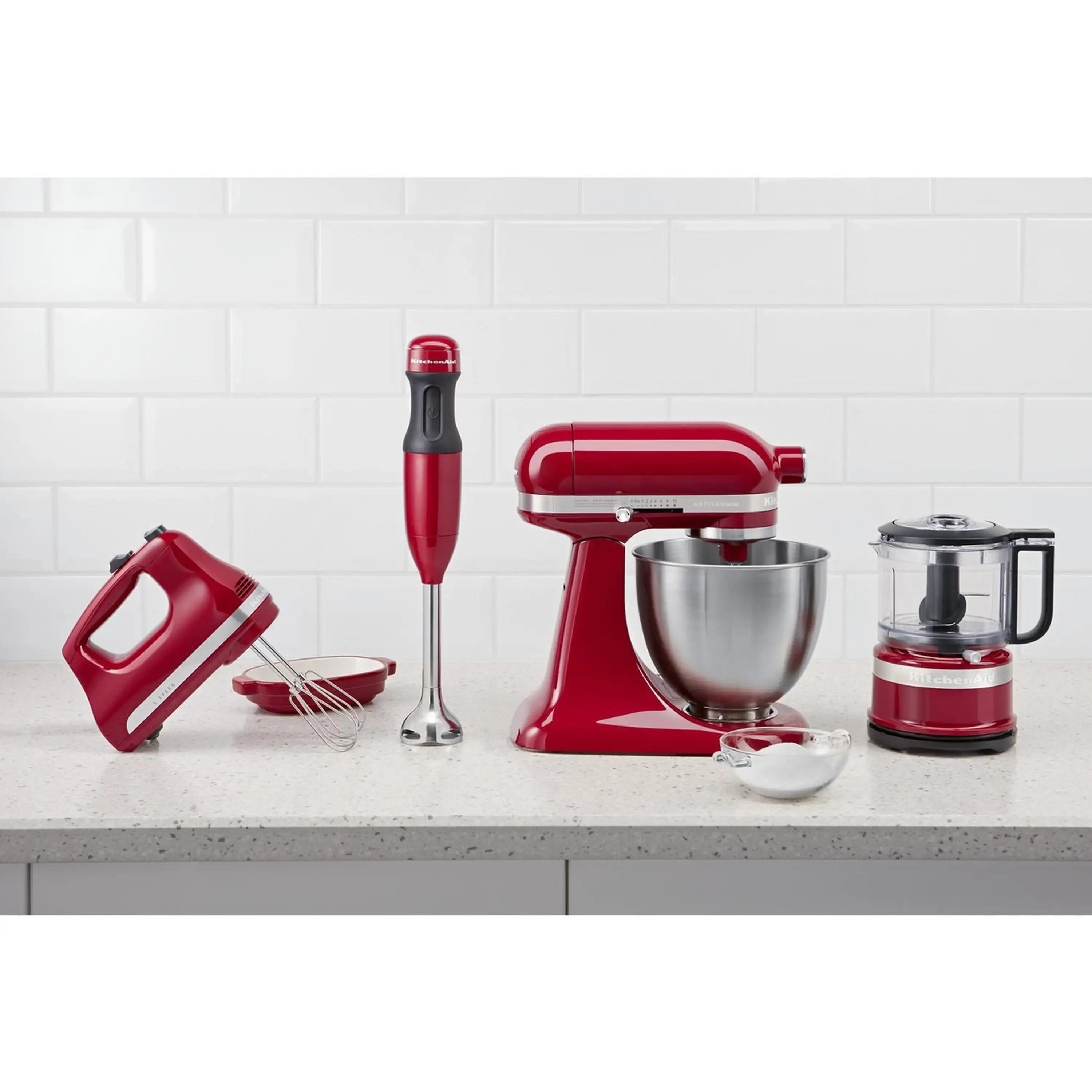 Red KitchenAid hand mixer and whisk/beaters attachments displayed on countertop