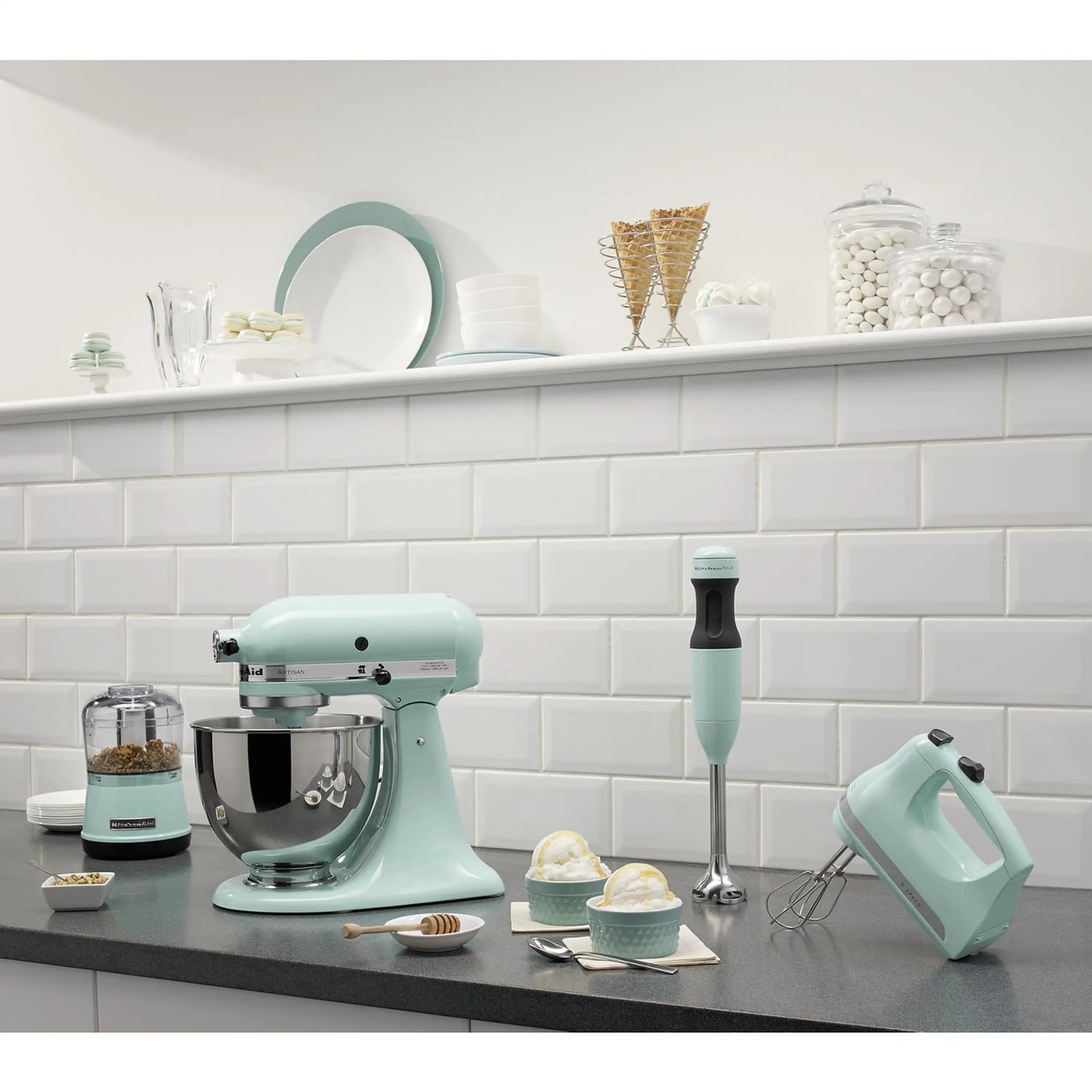 Ice-colored KitchenAid hand mixer and stand mixer set with beaters on kitchen counter