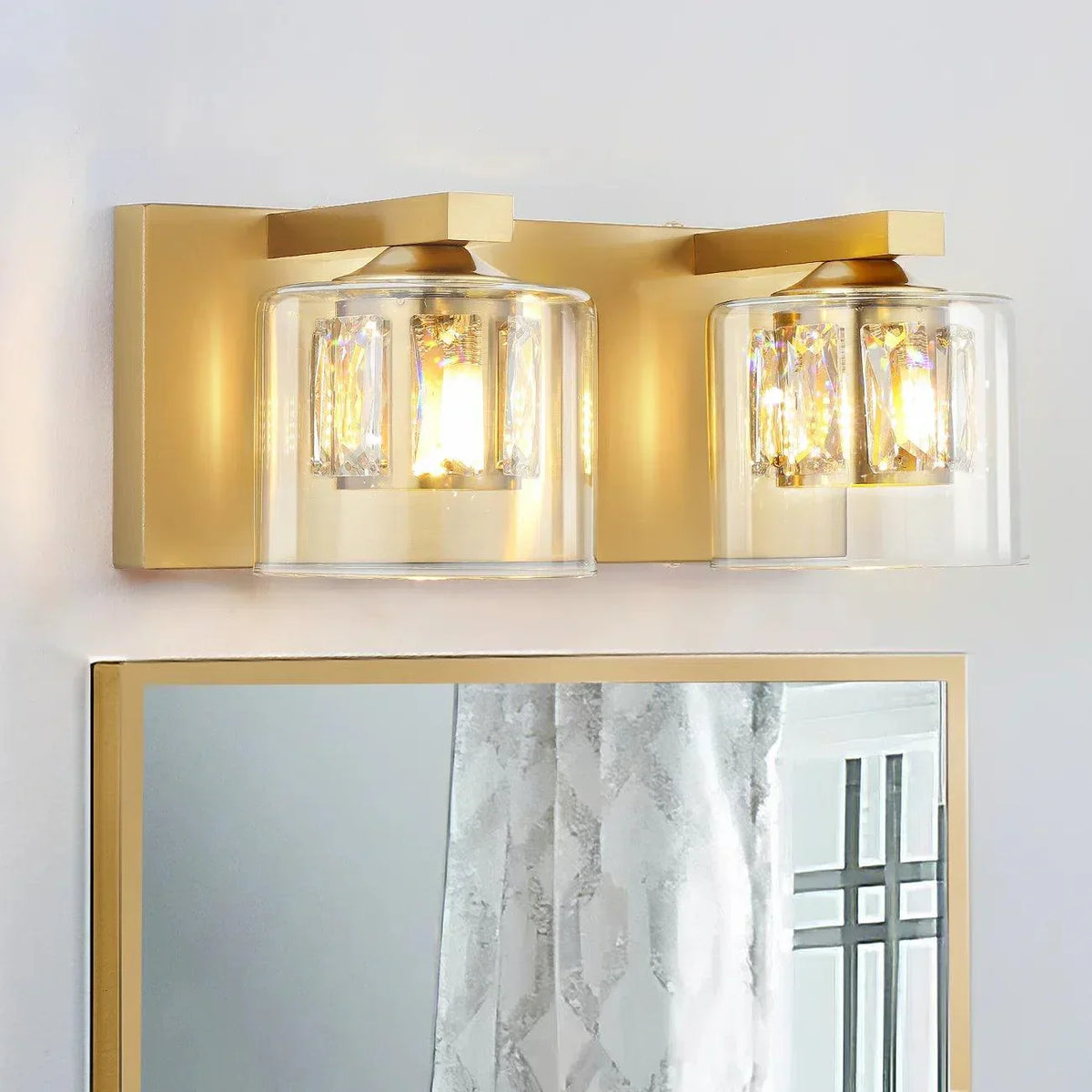 Golden 2-light bathroom vanity light with clear glass shades and polished metal frame