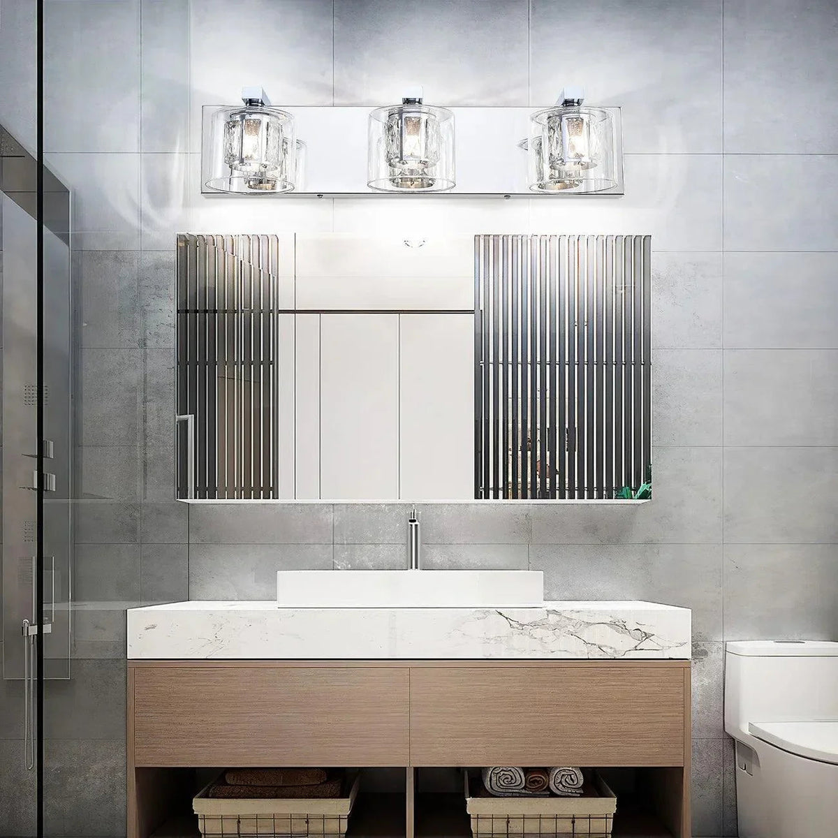 3-light vanity light over mirror with clear glass cylinders and chrome frame