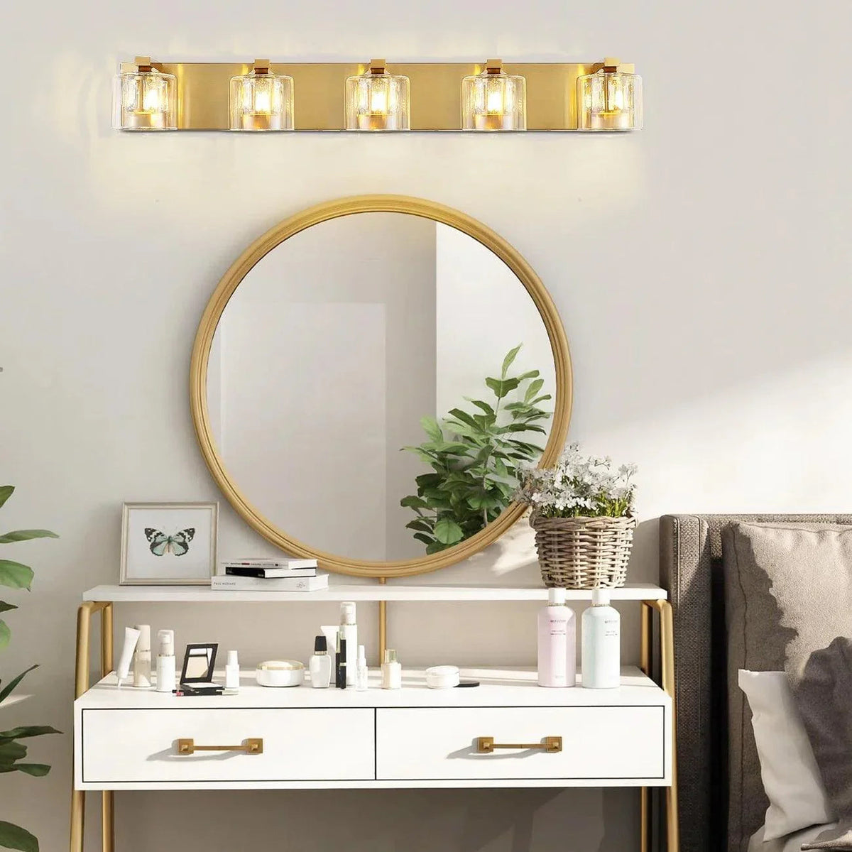 5-light bathroom vanity light with golden backplate and clear glass cylinder shades