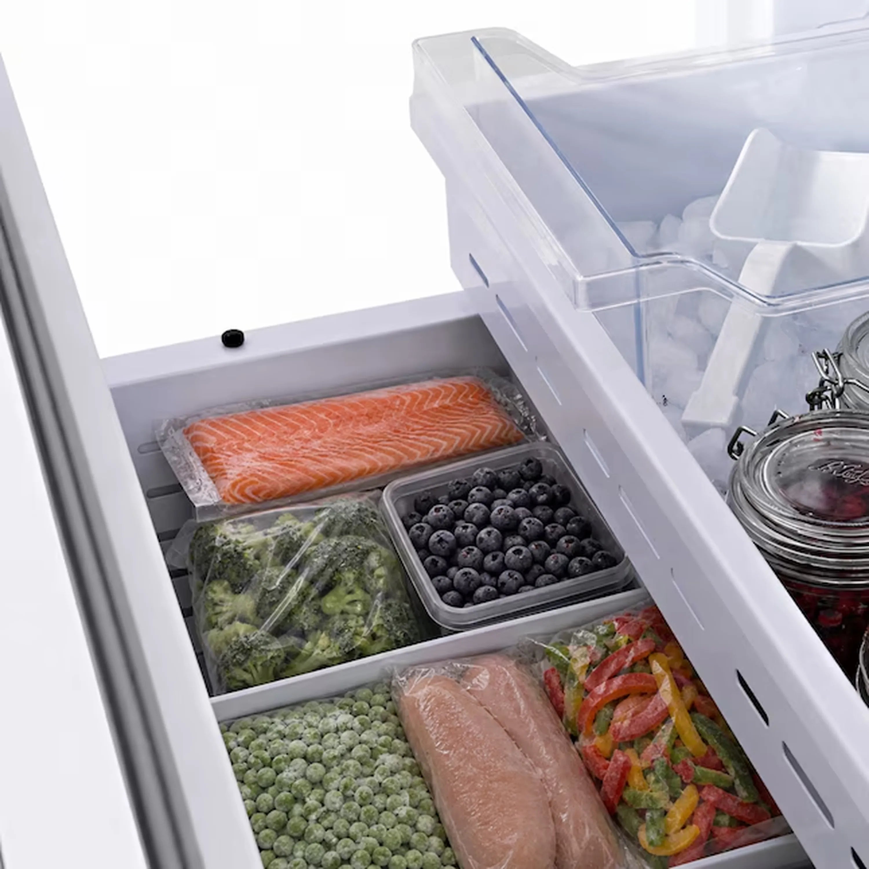 Built-in French door refrigerator with open freezer and fresh food bins