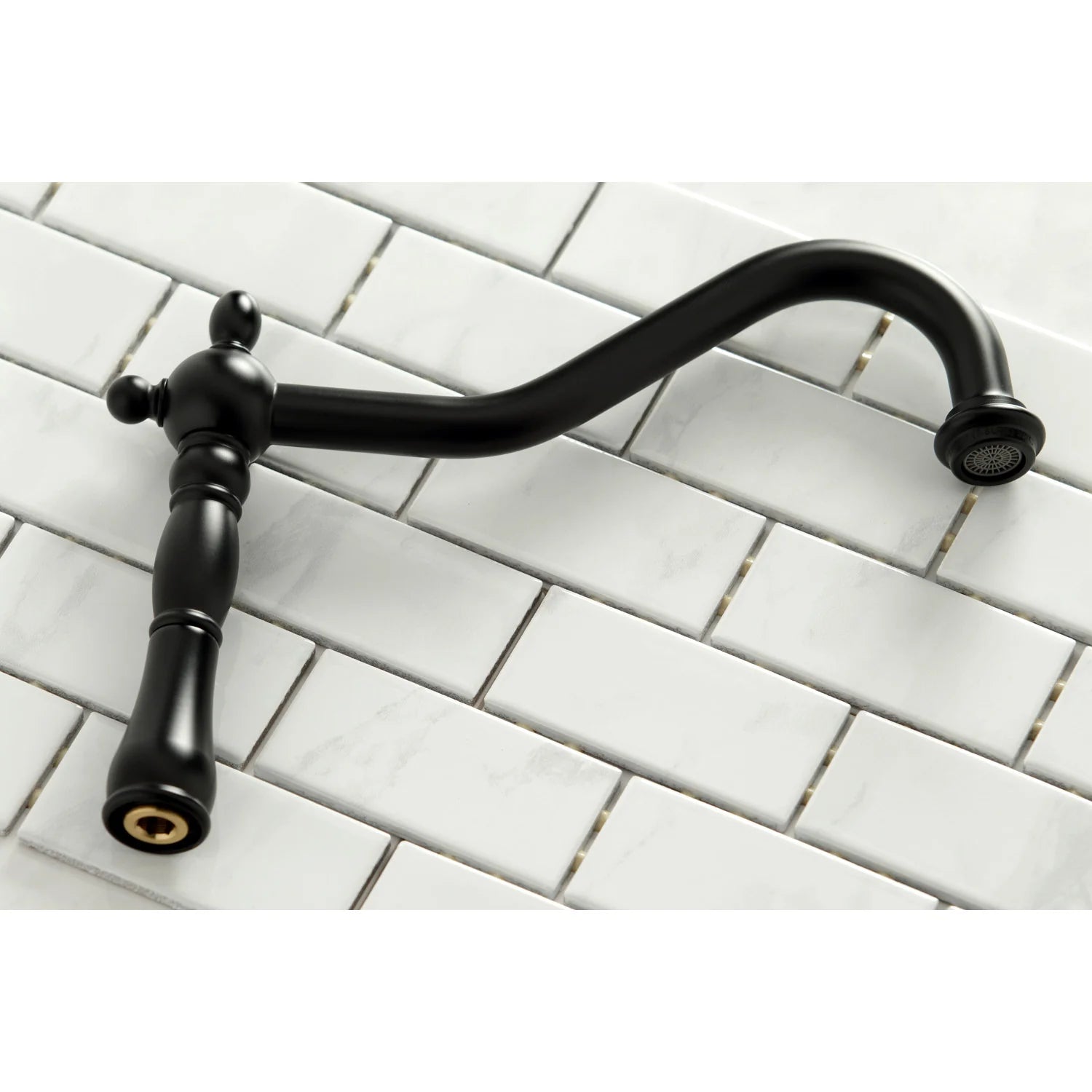 Matte black bridge kitchen faucet with arched spout over white tile