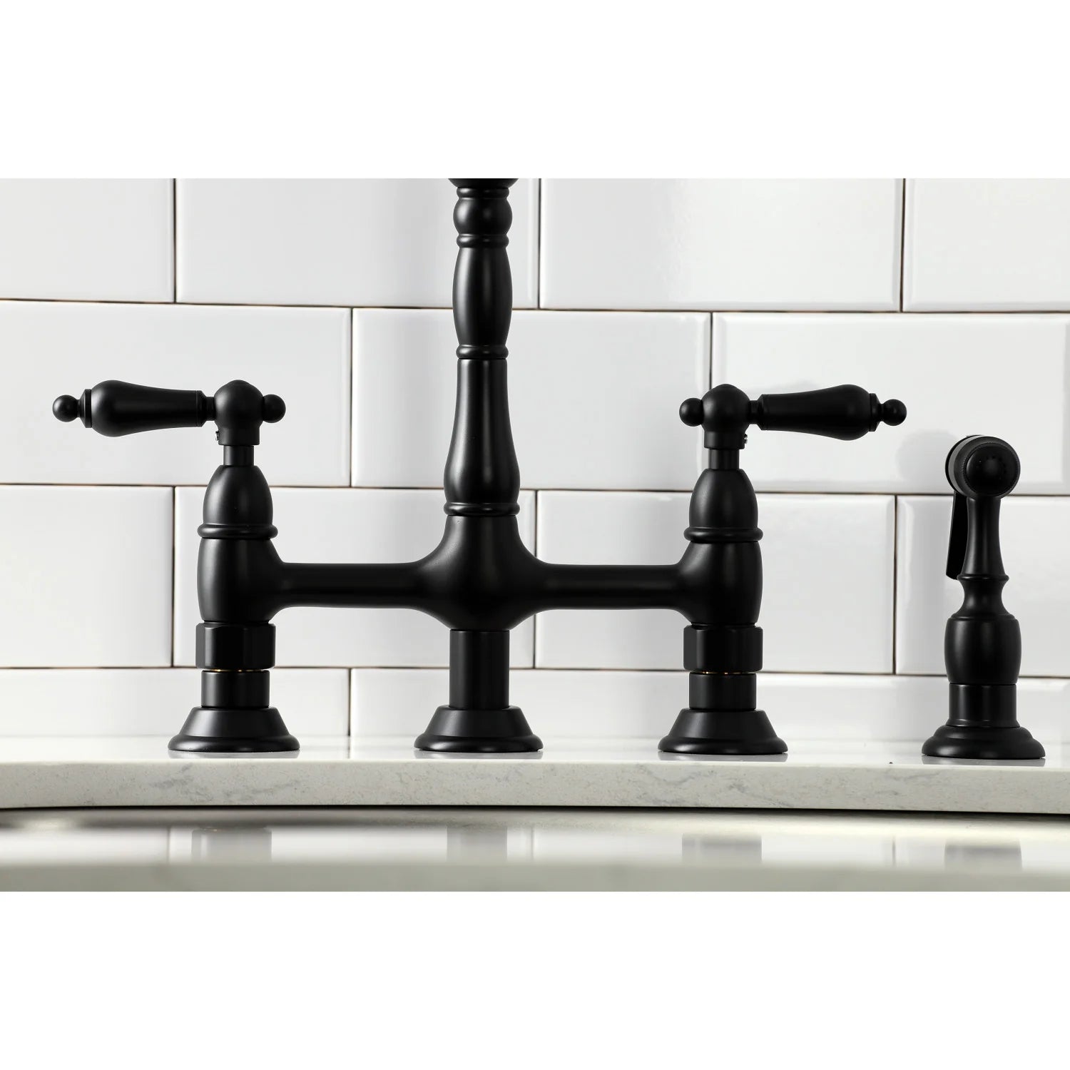 Matte black bridge kitchen faucet front view with three handles and sprayer