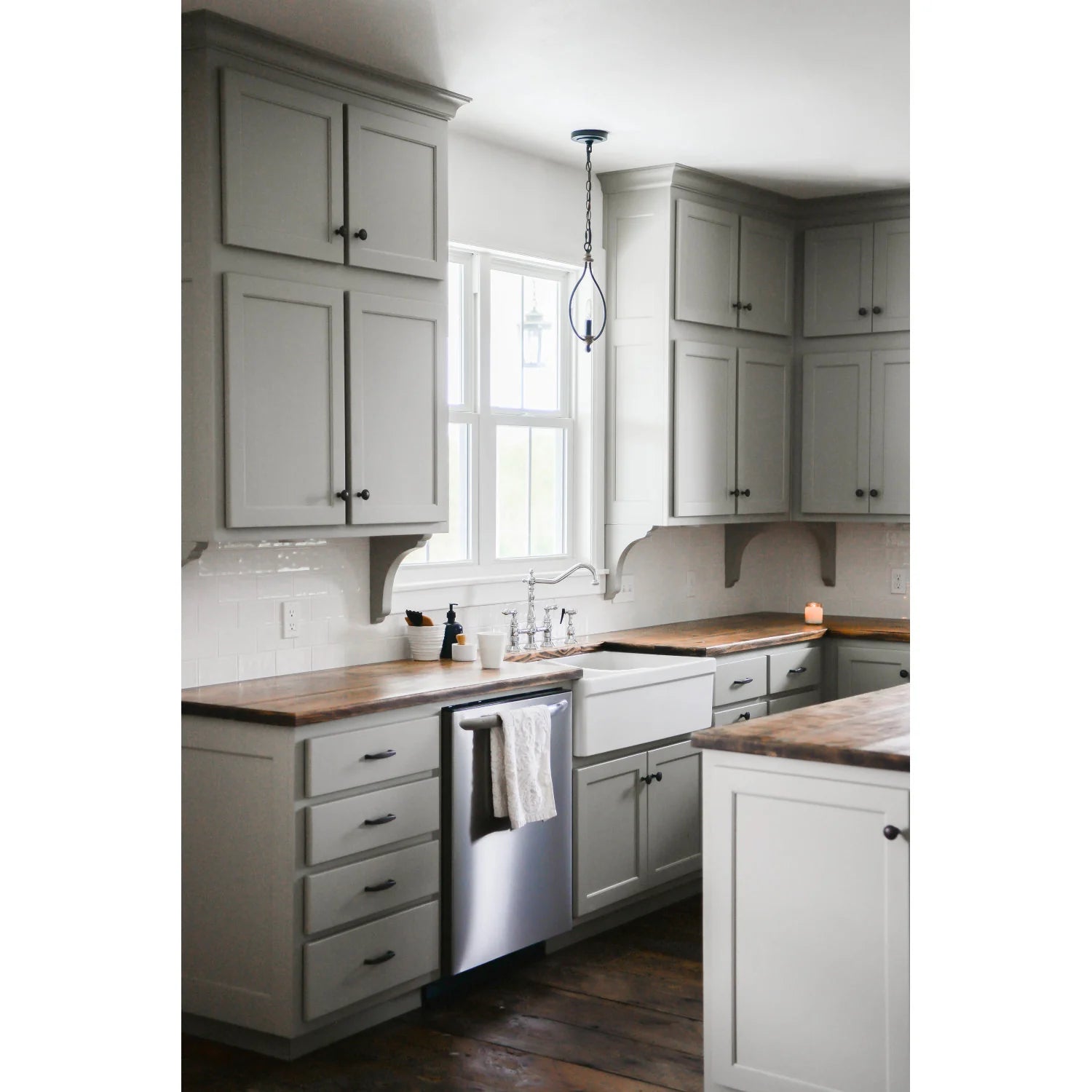 Polished chrome bridge kitchen faucet with cross handles and side sprayer