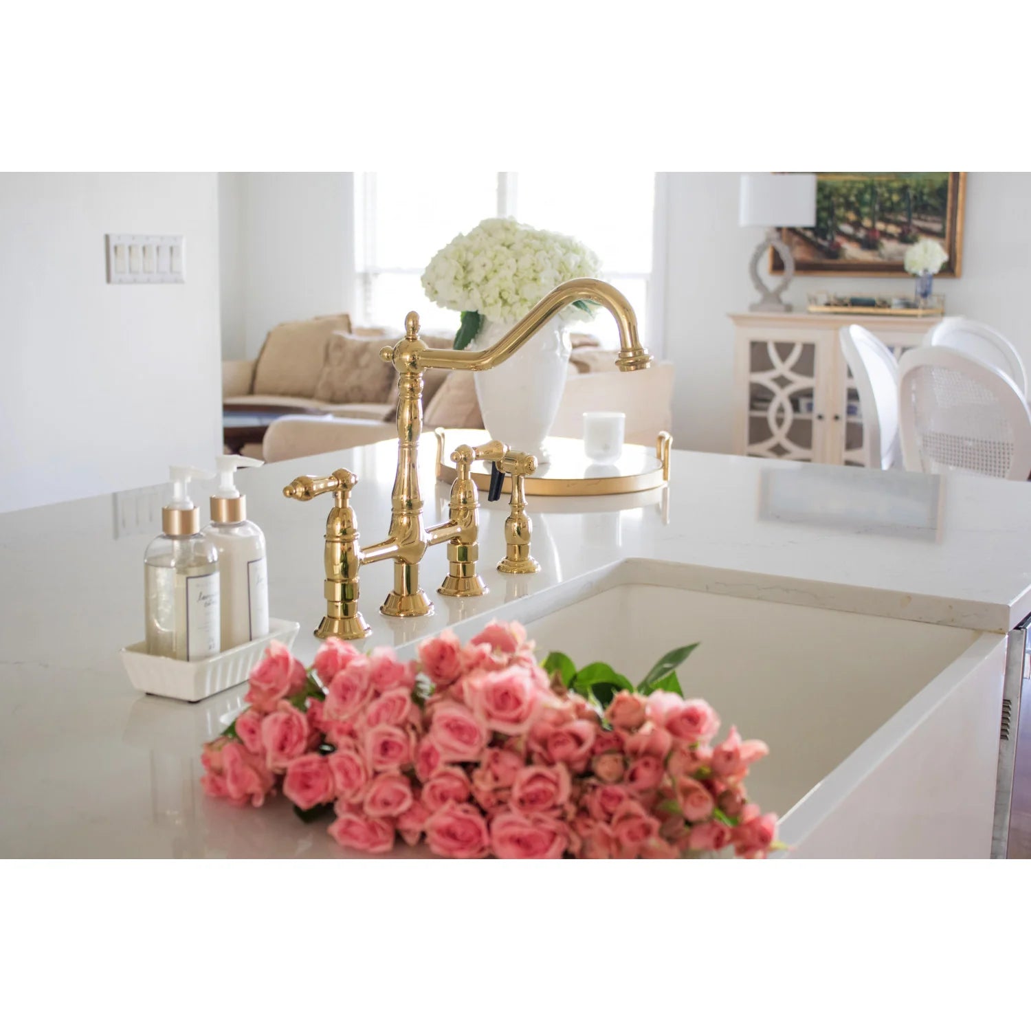 Polished brass bridge kitchen faucet with side sprayer and tall curved spout