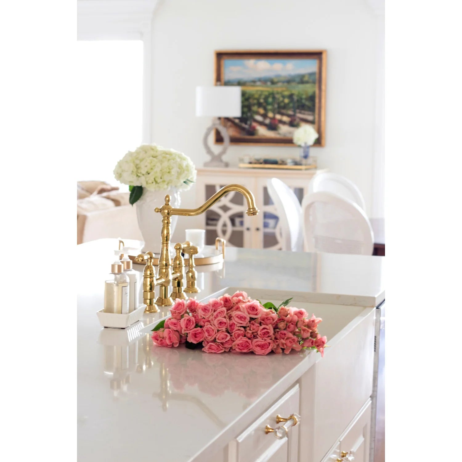 Polished brass bridge kitchen faucet with side sprayer and curved spout