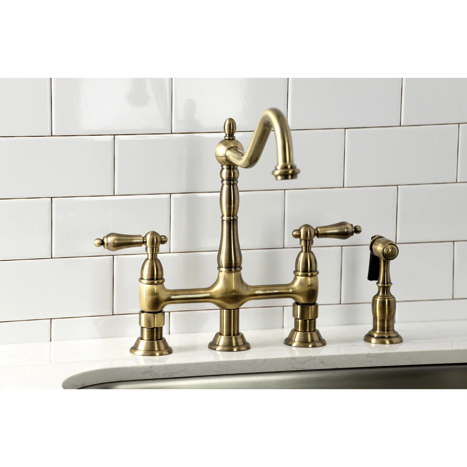 Antique brass bridge kitchen faucet with side sprayer and three control handles