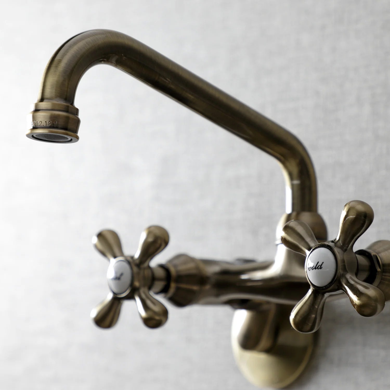 Antique brass bridge faucet with arched spout and two cross handles