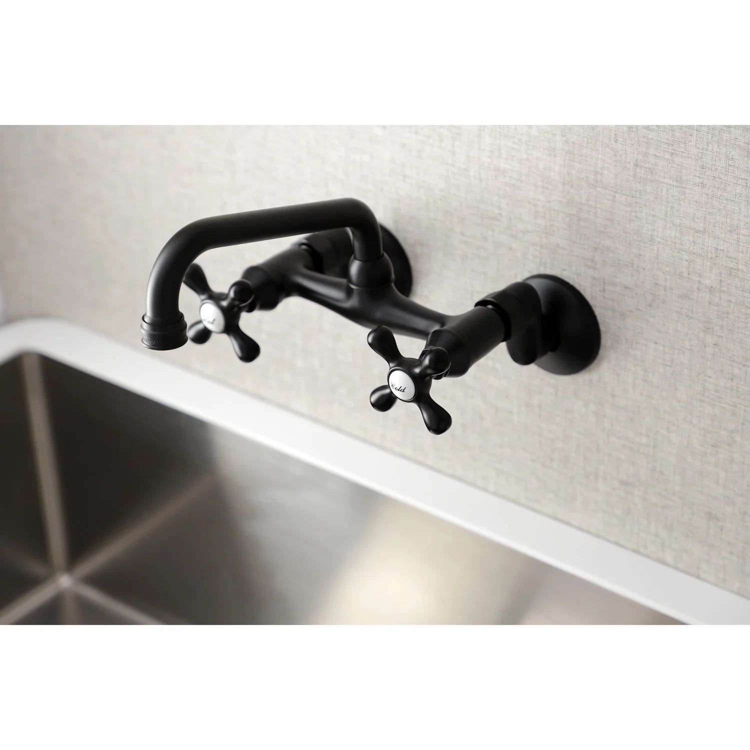 Matte black wall-mount bridge faucet with two cross handles and curved spout