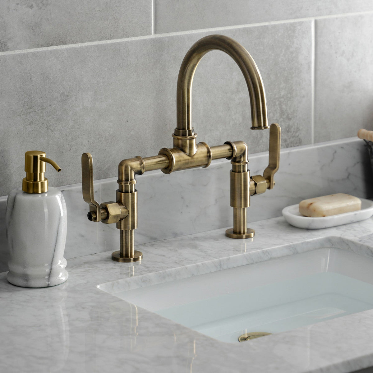 Whitaker Industrial Style Bridge Bathroom Faucet with Pop-Up Drain in Antique Brass