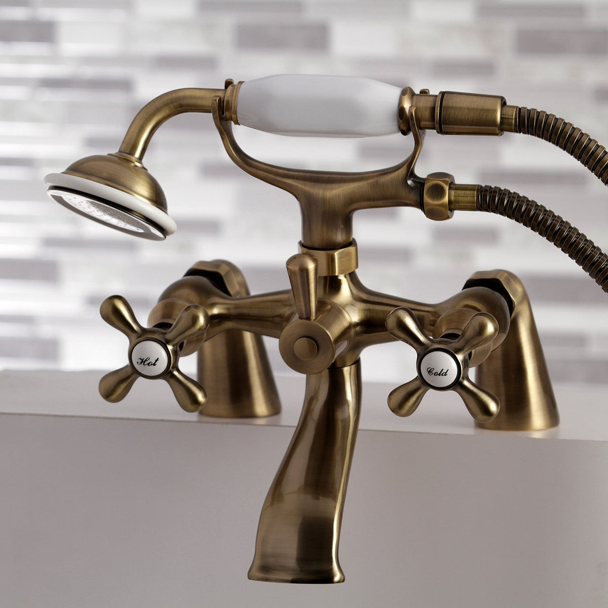 Kingston 6" Center Deck-Mount Clawfoot Tub Faucet with Hand Shower in Antique Brass