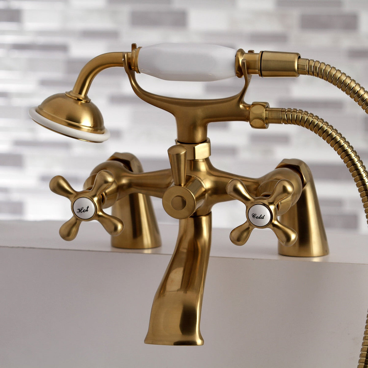 Kingston 6" Center Deck-Mount Clawfoot Tub Faucet with Hand Shower in Brushed Brass