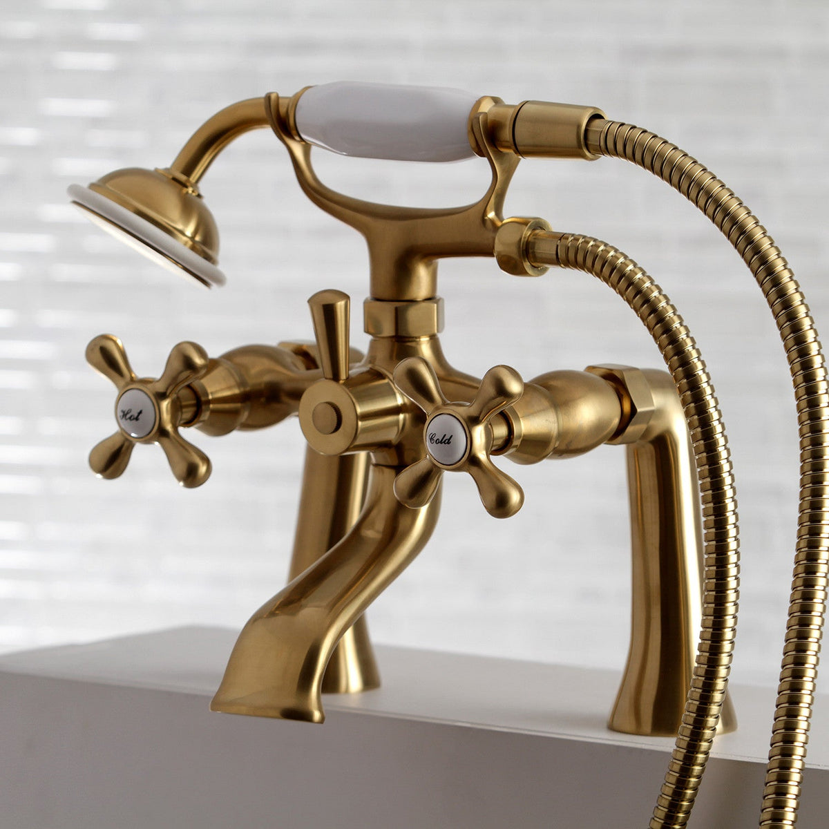 Kingston 7" Center Deck-Mount Clawfoot Tub Faucet with Hand Shower in Brushed Brass