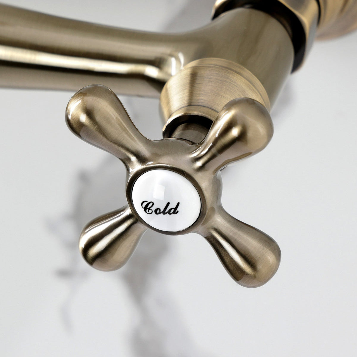 Vintage Double-Handle 2-Hole Wall Mount Bathroom Faucet in Antique Brass