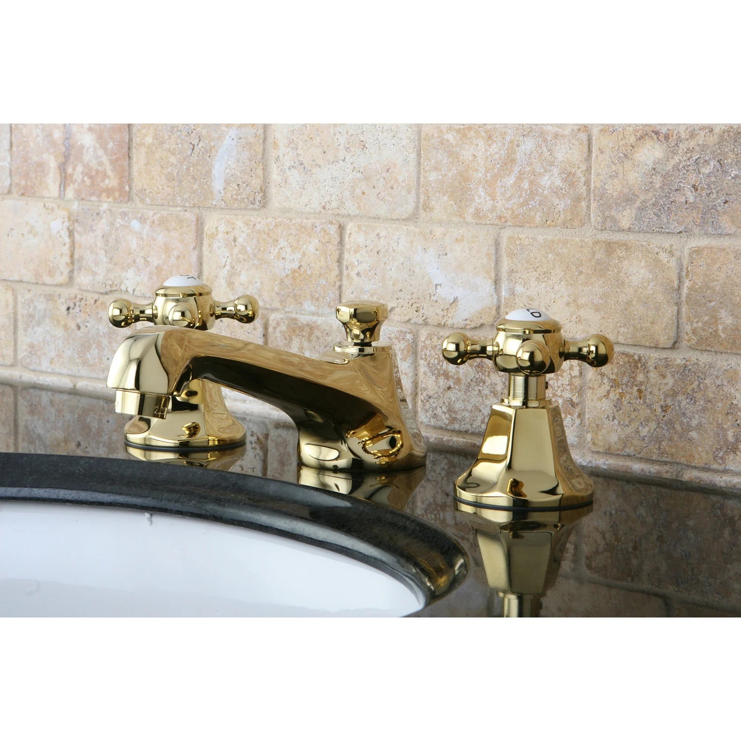 Polished brass widespread bathroom faucet mounted on sink with two control handles