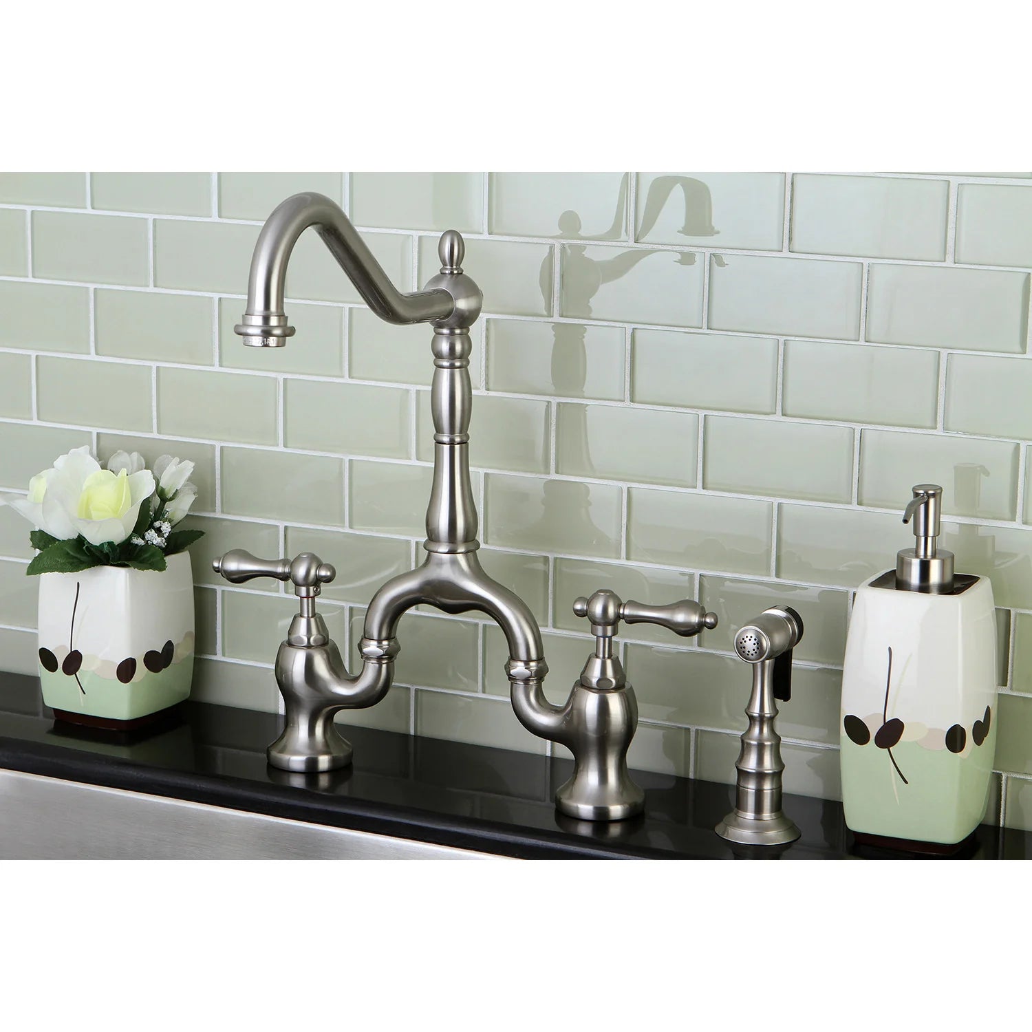 Brushed nickel bridge kitchen faucet with side sprayer and two cross handles