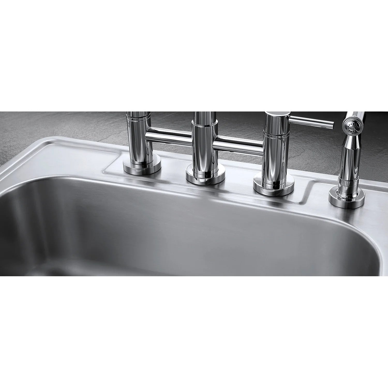 Polished chrome bridge kitchen faucet with side sprayer over stainless sink