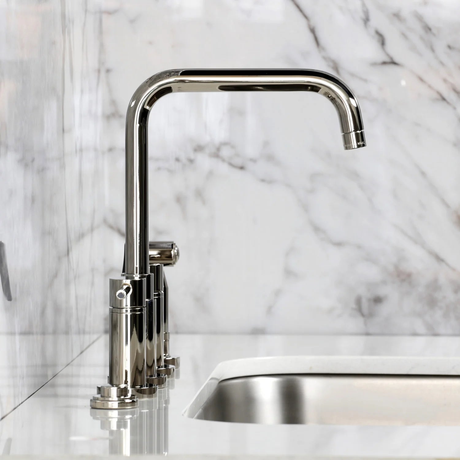 Polished nickel bridge kitchen faucet with curved spout and side sprayer assembly