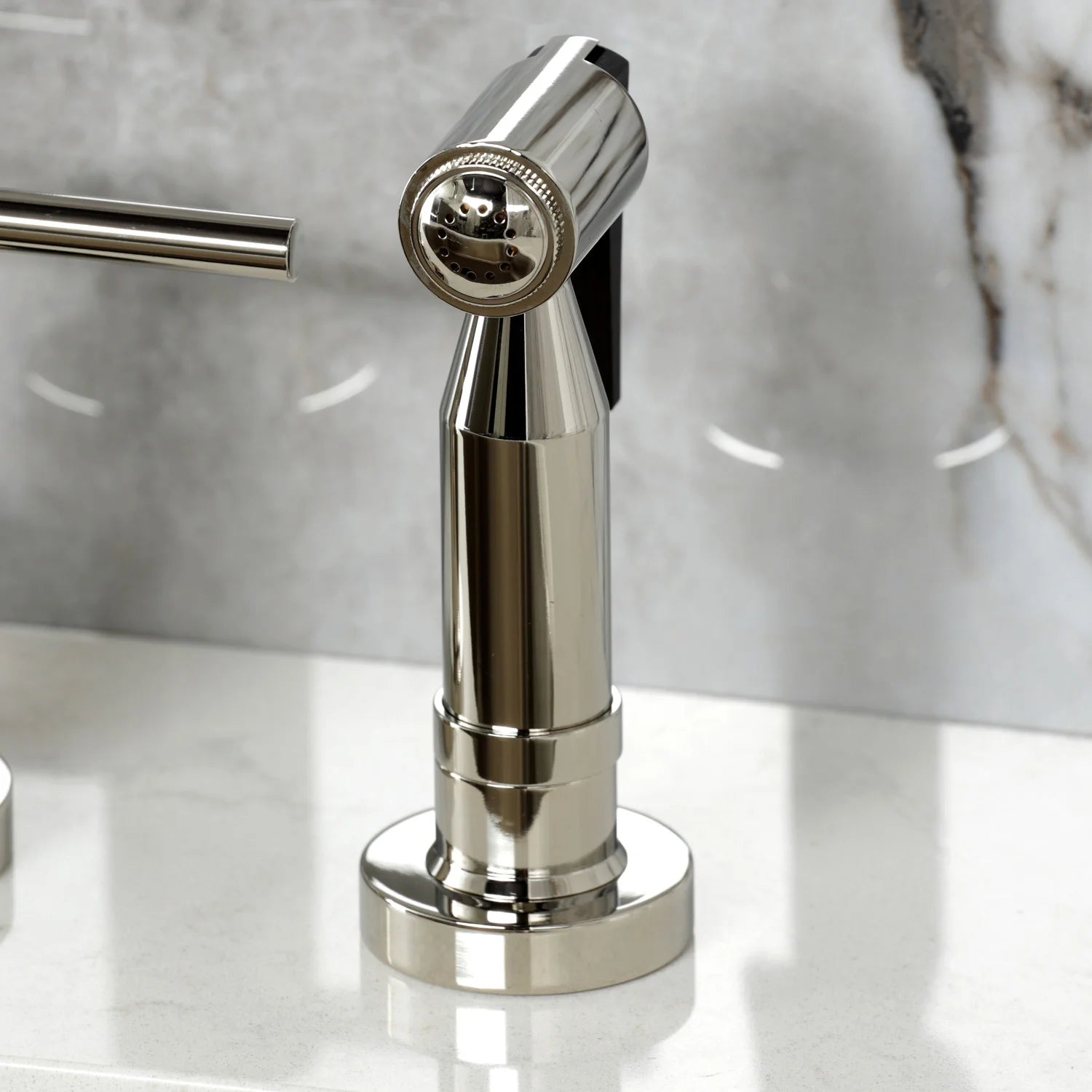 Polished nickel spray head with round nozzles on a short diverter stem