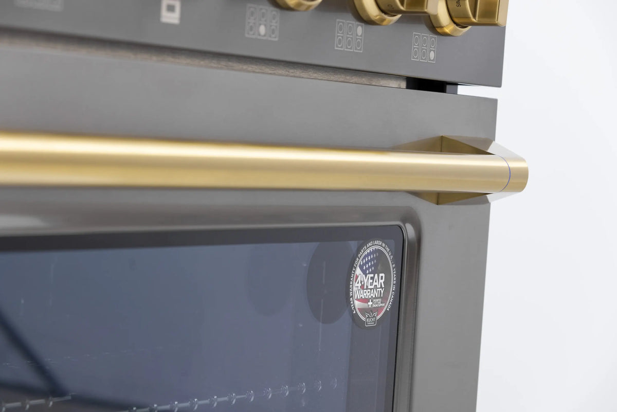 Dark stainless oven door with gold handle and 4-year warranty label