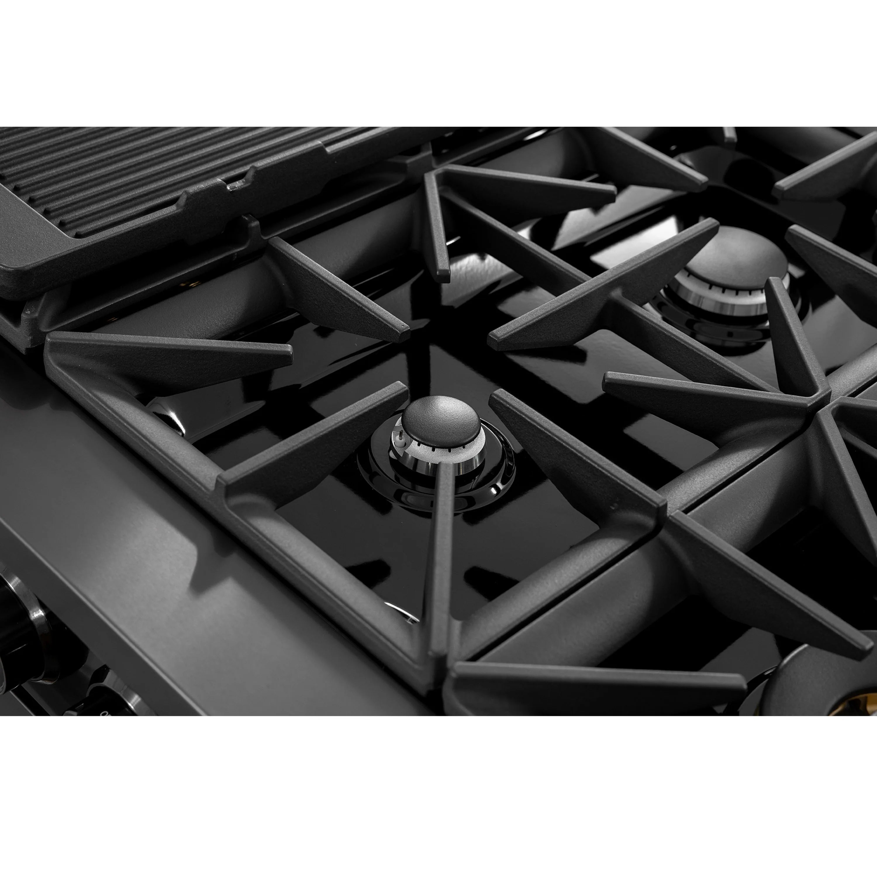 Gas cooktop burner with black cast-iron grate and round burner cap