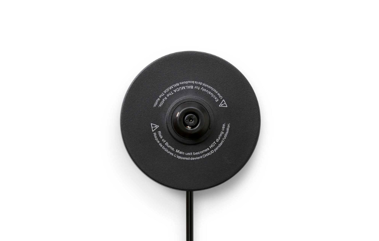 Black kettle base underside with central opening and safety symbols.