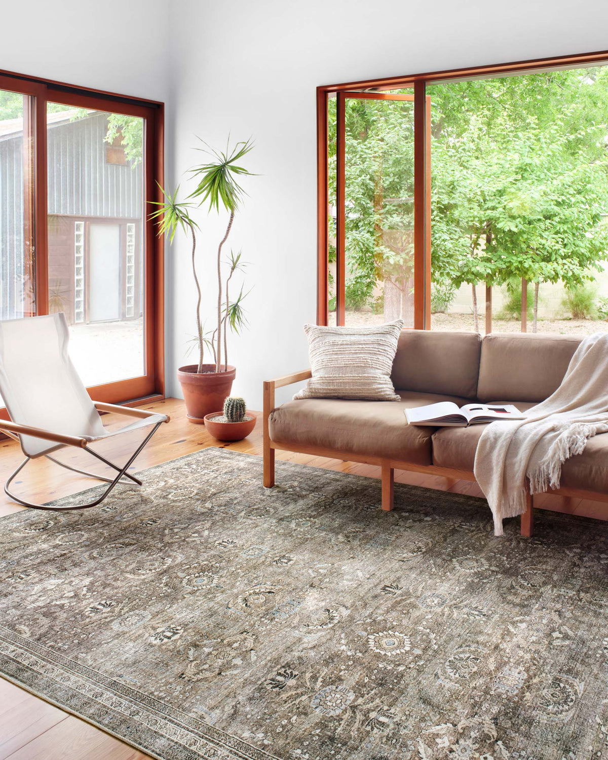 Large traditional area rug with distressed medallion pattern, antique gray and moss highlights