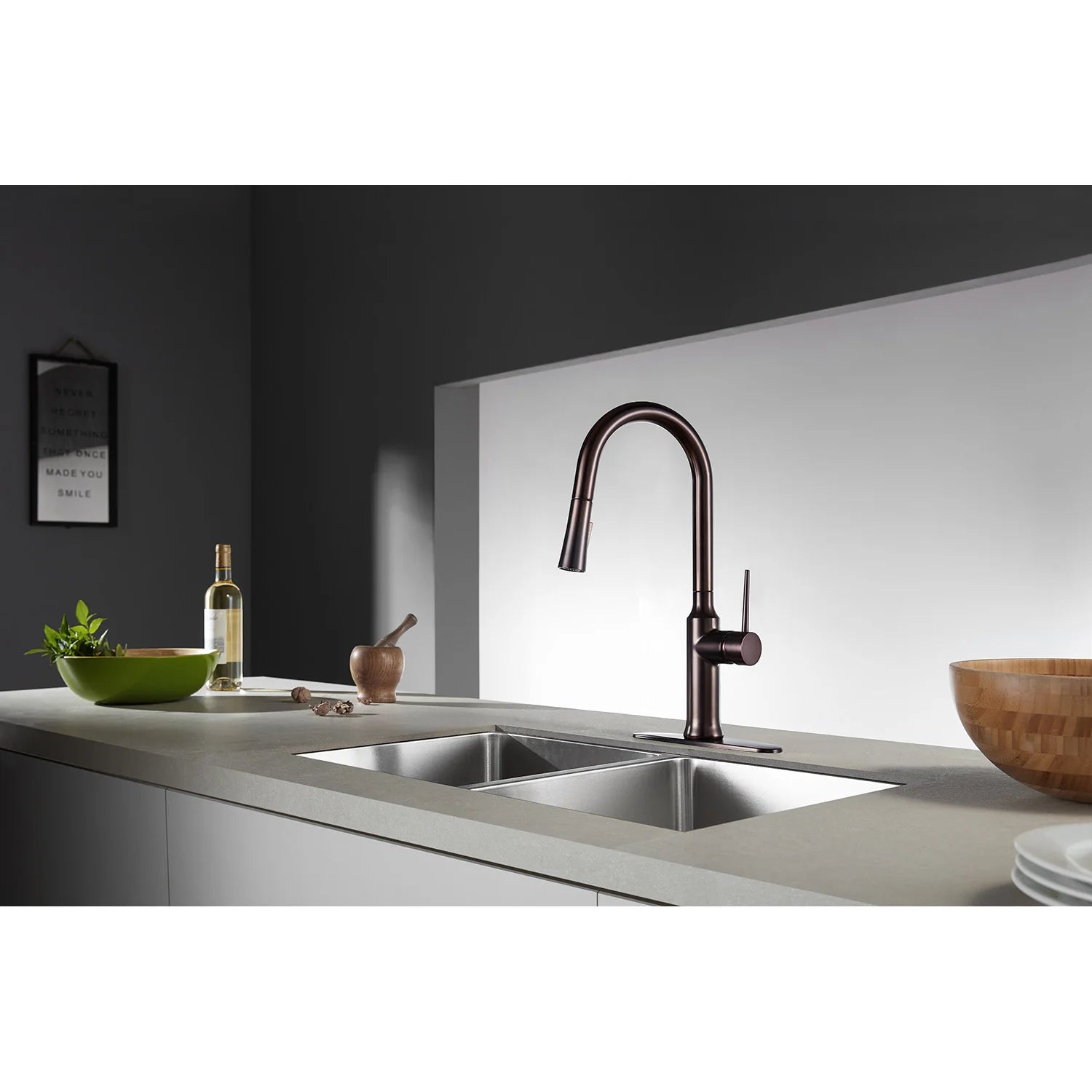 Oil rubbed bronze single-handle kitchen faucet with arched spout over double sink