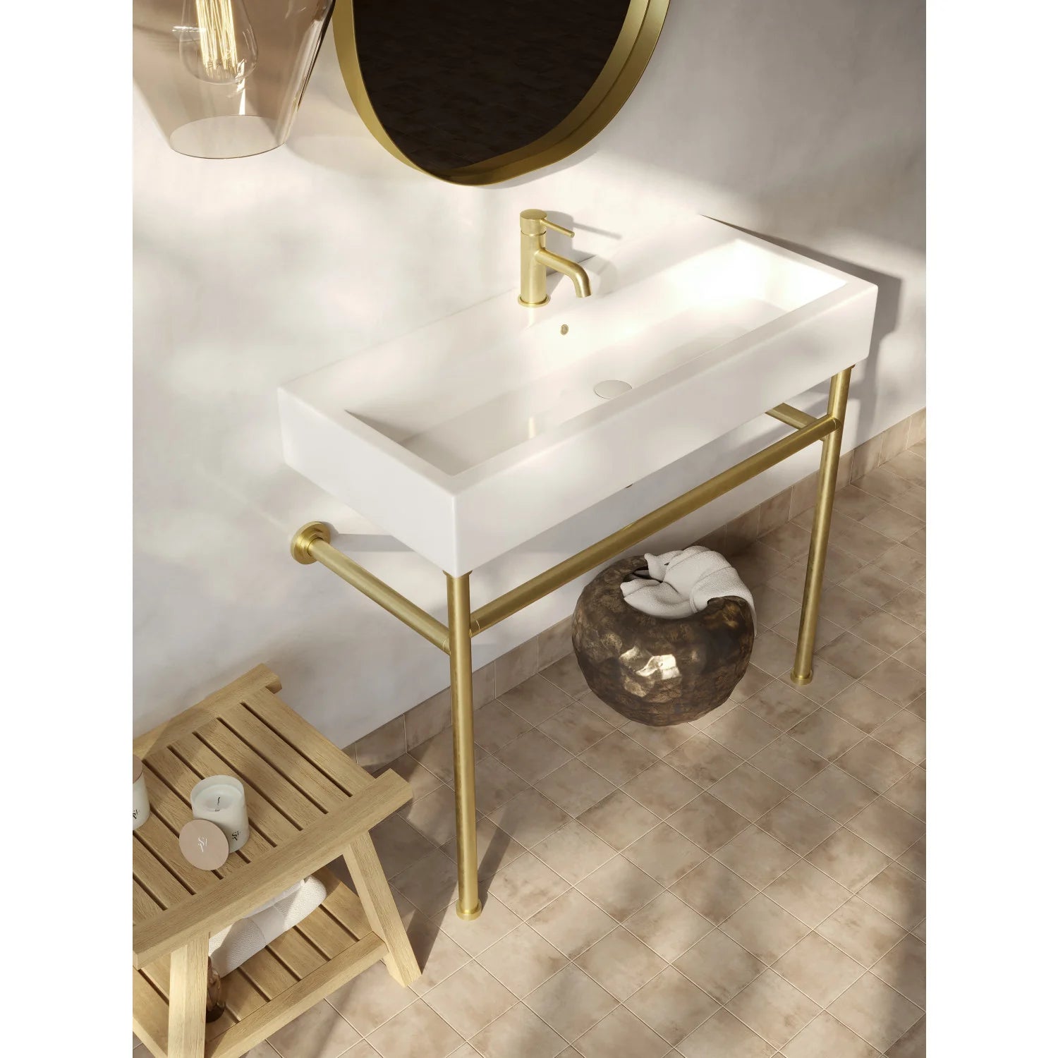 Brushed brass bathroom faucet with tall spout and cylindrical handle on countertop