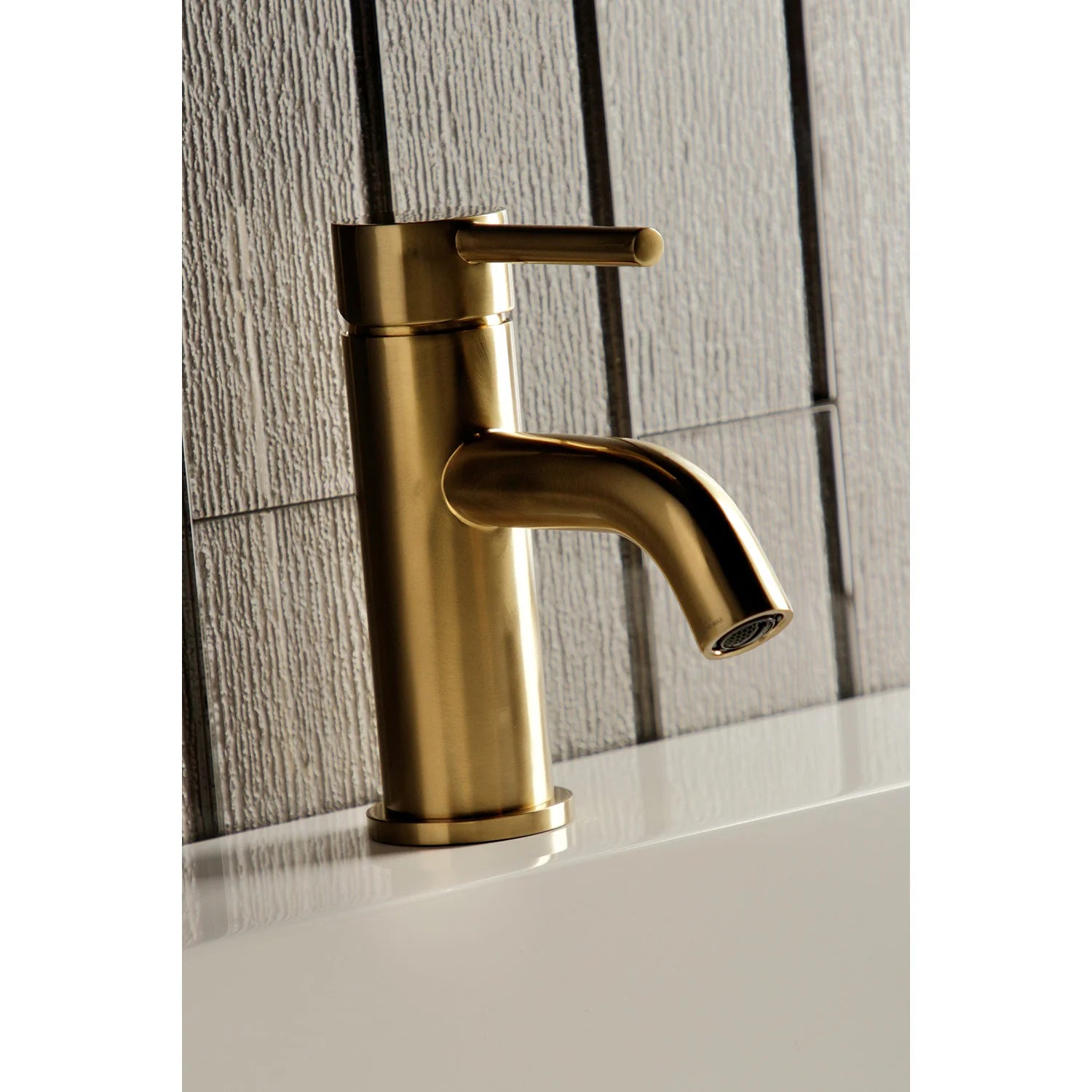 Brushed brass bathroom faucet showing cylindrical handle and short outlet spout