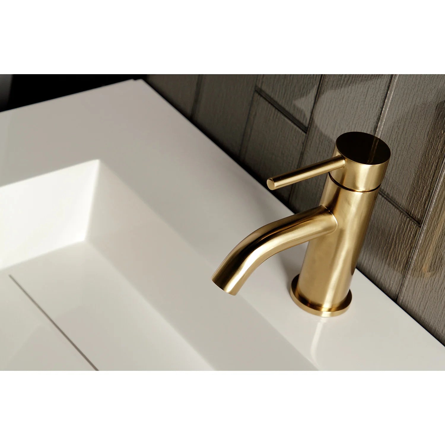 Brushed brass one-handle bathroom faucet in angled view with curved spout