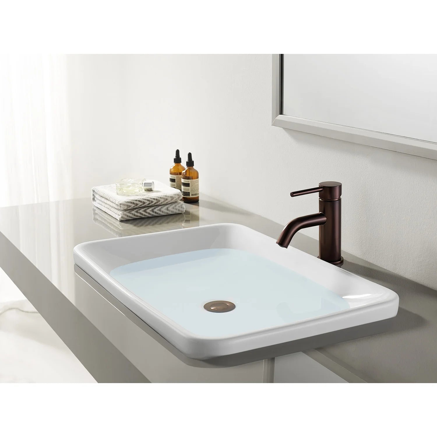 Oil-rubbed bronze bathroom faucet with single handle on a white vessel sink