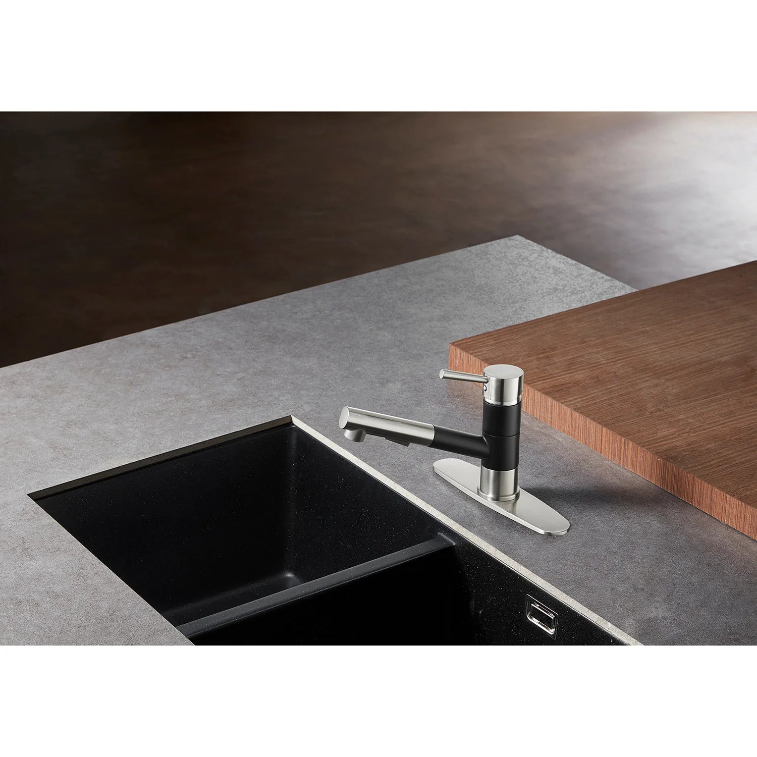 Pull-out kitchen faucet over black undermount sink, matte black and brushed nickel