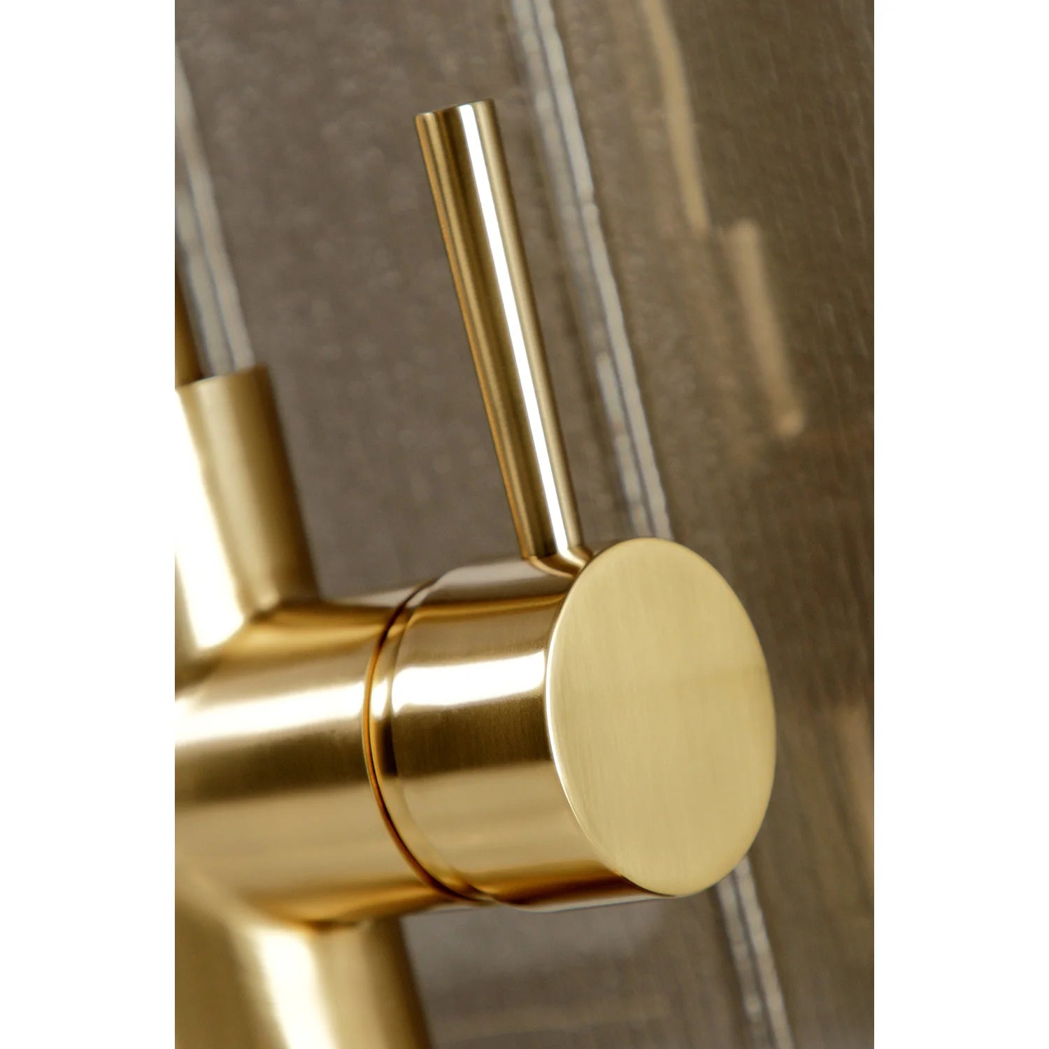 Brushed brass single-handle kitchen faucet control lever on mounting base