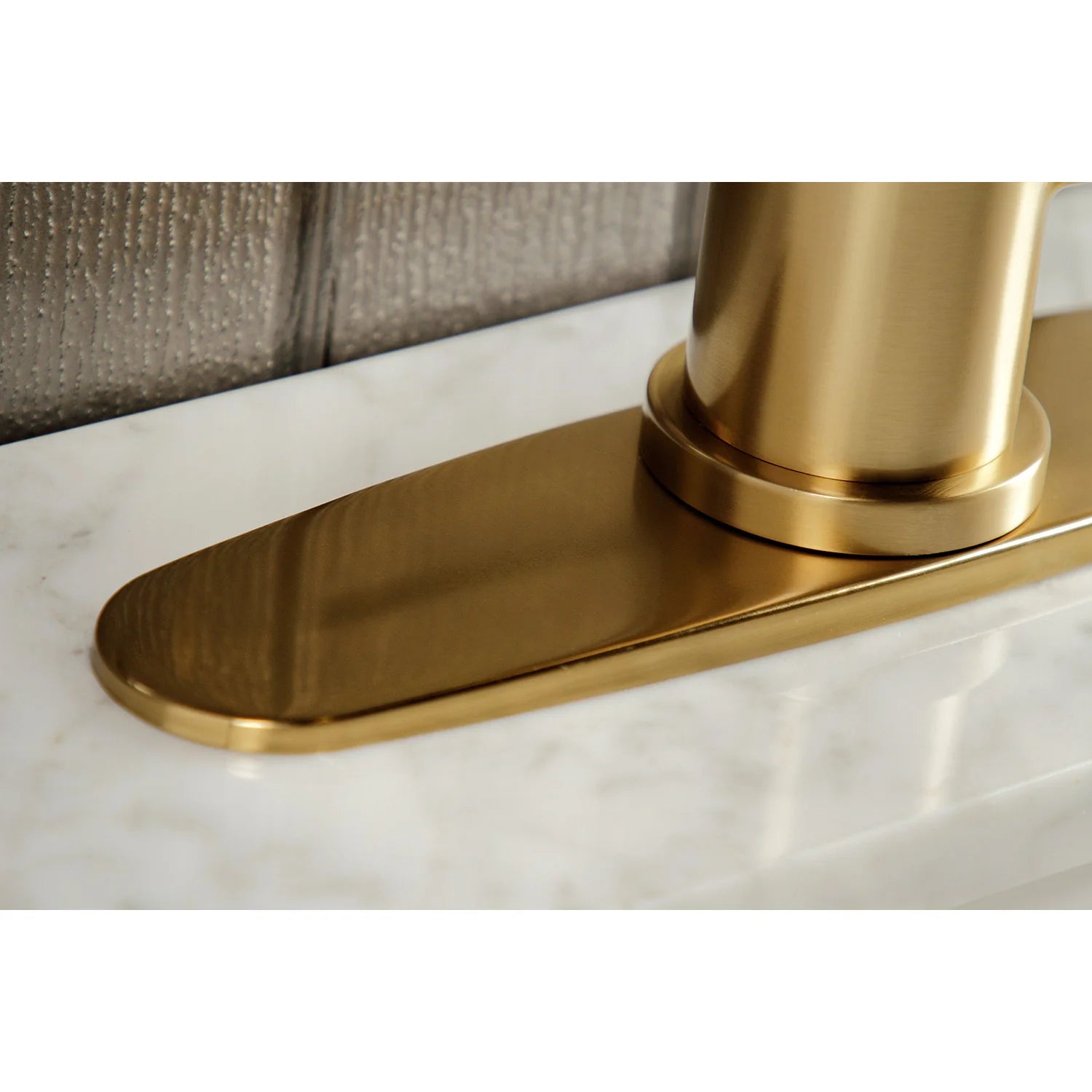 Brushed brass faucet base plate on sink deck with mounted spout