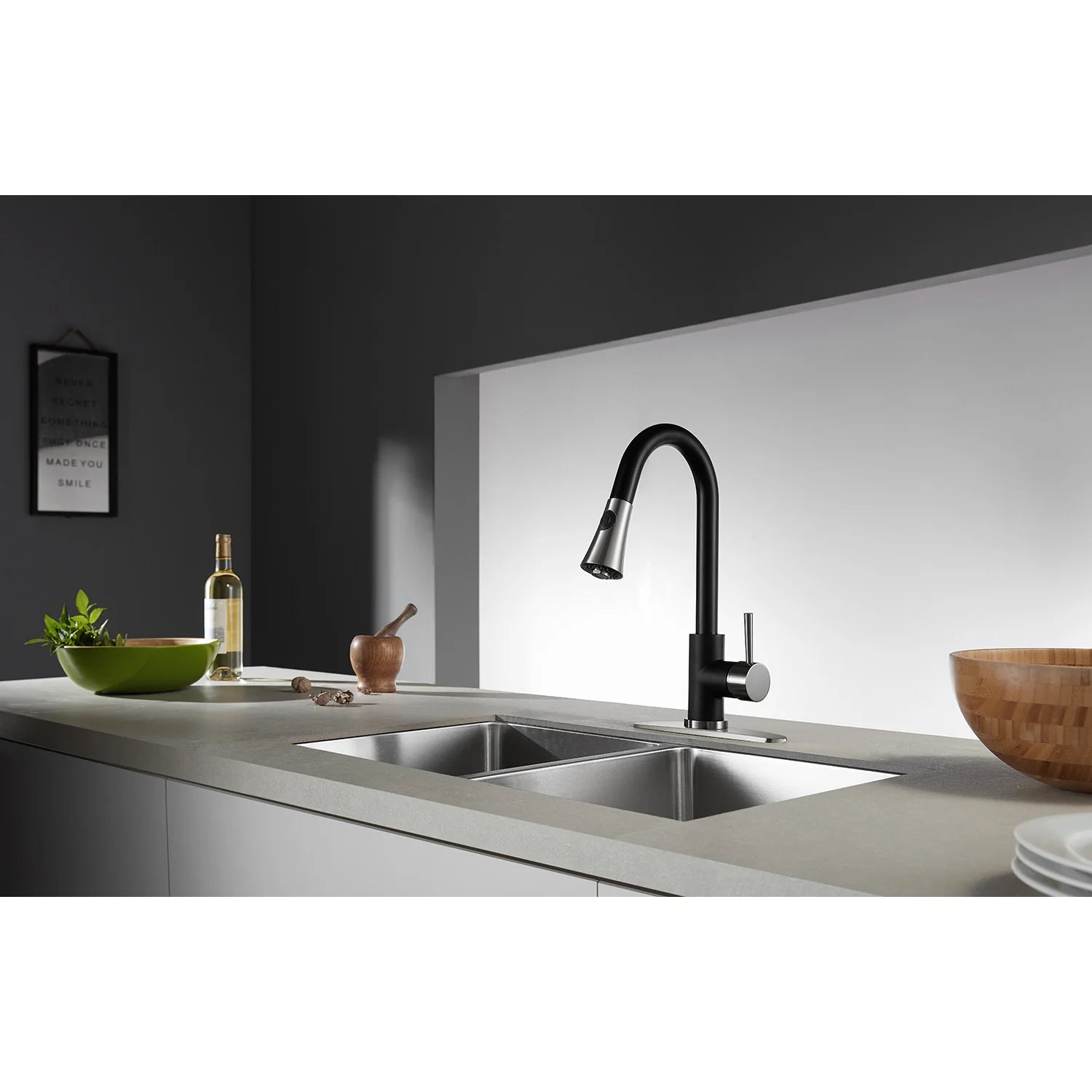 Matte black kitchen faucet with single lever and pull-down sprayer over sink